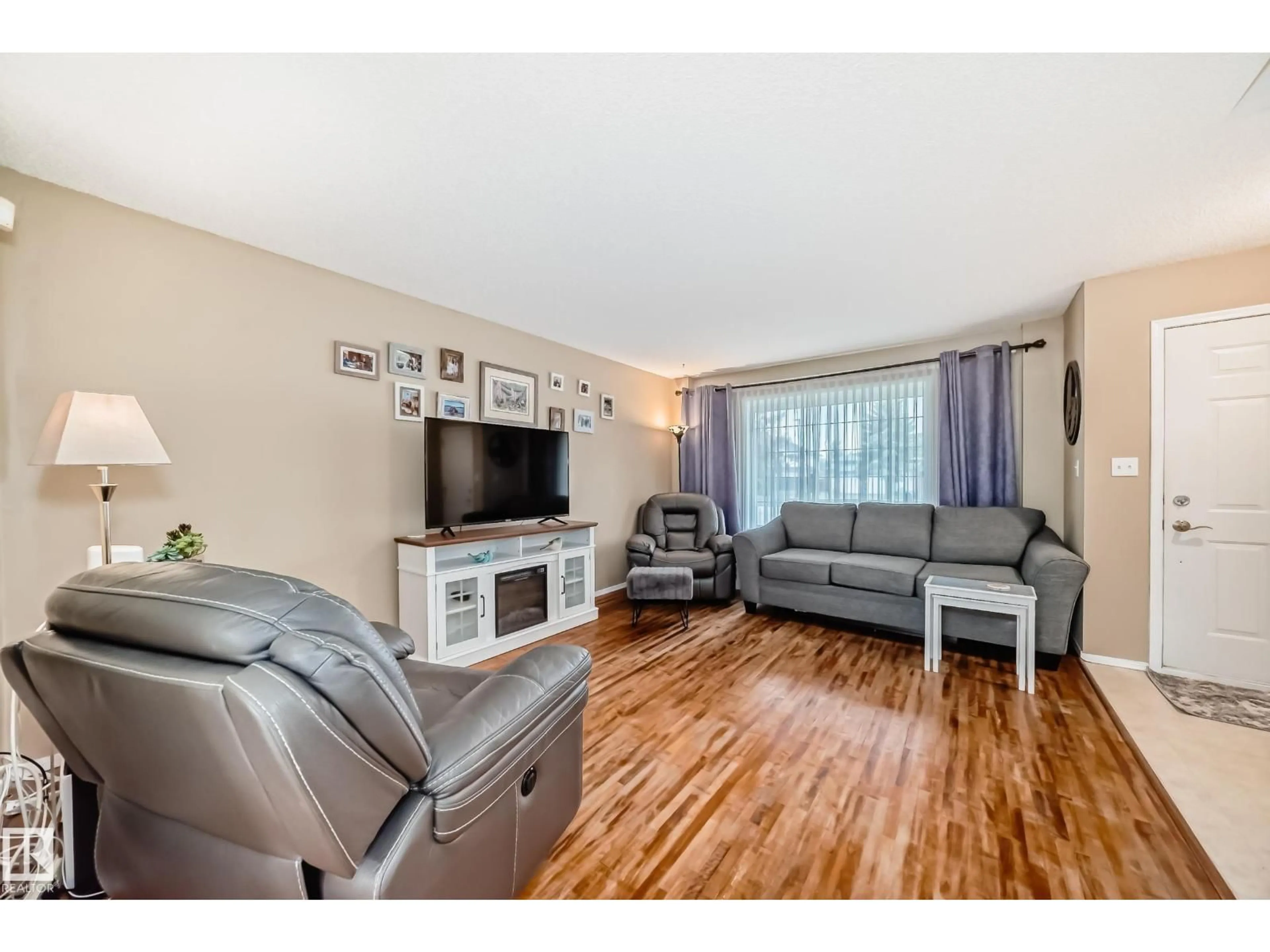 Living room with furniture, wood/laminate floor for 11831 9 AV, Edmonton Alberta T6J7A1