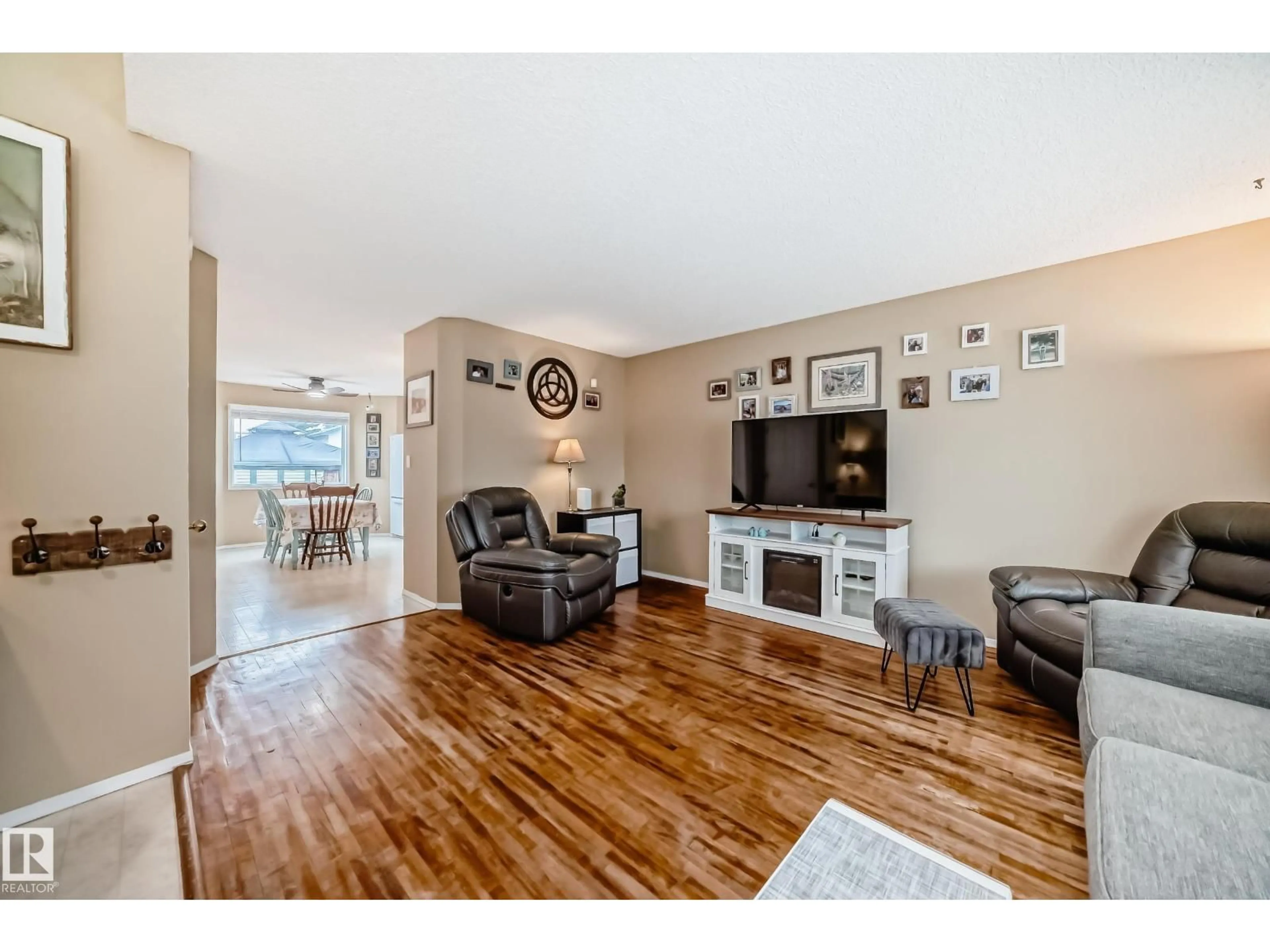 Living room with furniture, wood/laminate floor for 11831 9 AV, Edmonton Alberta T6J7A1