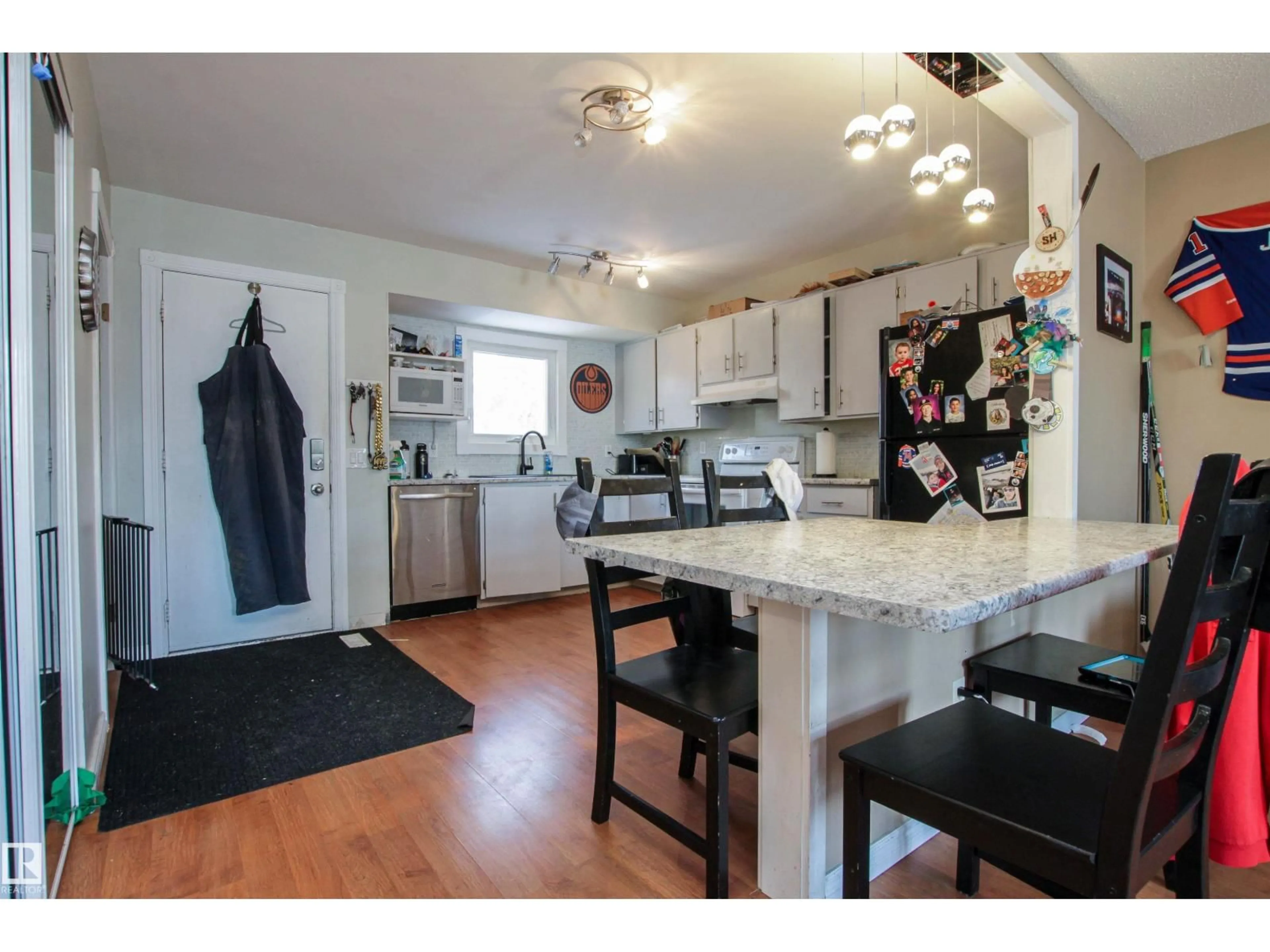 Open concept kitchen, wood/laminate floor for 2415 49A ST, Edmonton Alberta T6L3X2