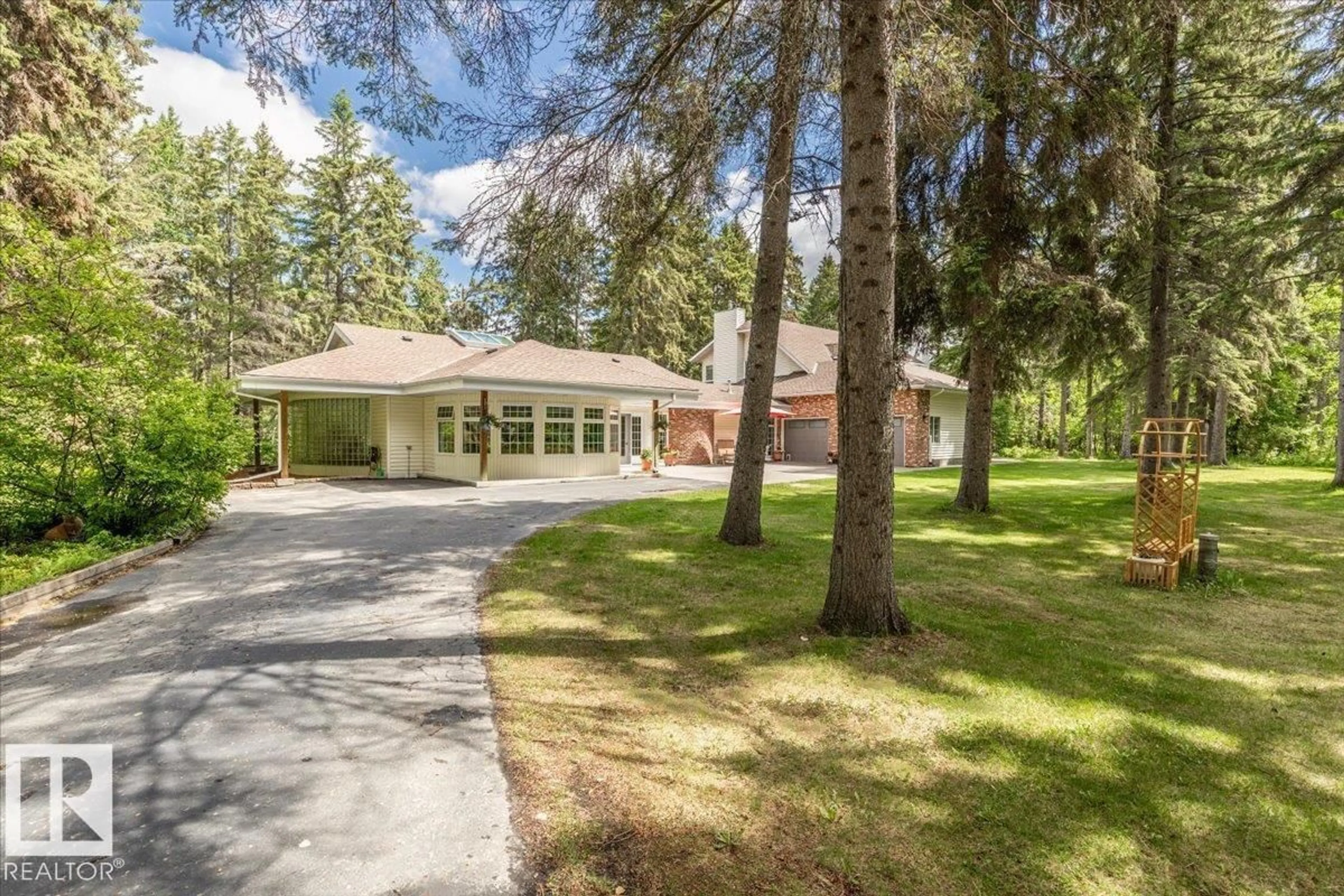A pic from outside/outdoor area/front of a property/back of a property/a pic from drone, forest/trees view for #104 - 244013 TWP ROAD 470, Rural Wetaskiwin County Alberta T9A1W8