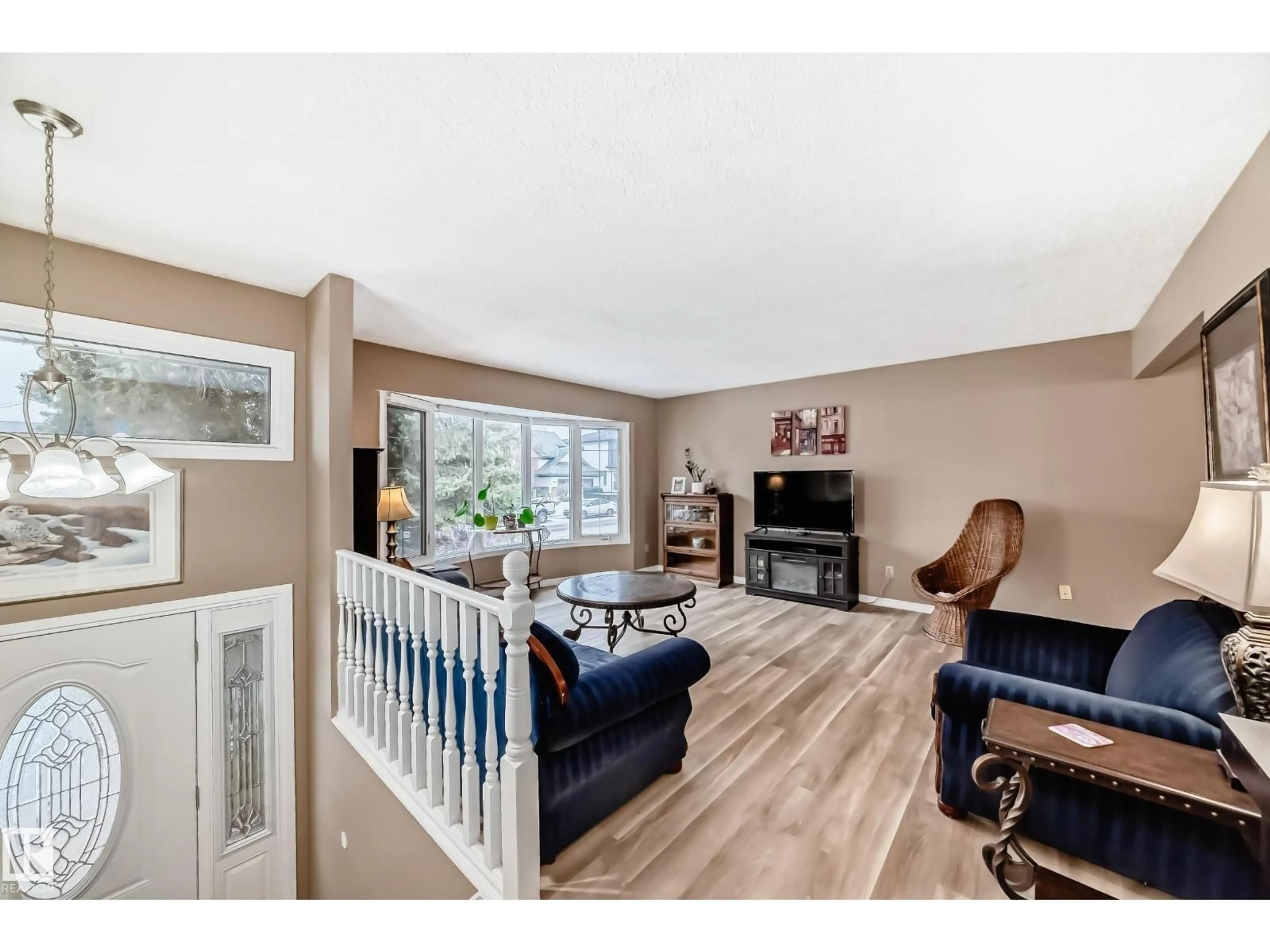 Living room with furniture, wood/laminate floor for 9813 152 ST, Edmonton Alberta T5X1X2