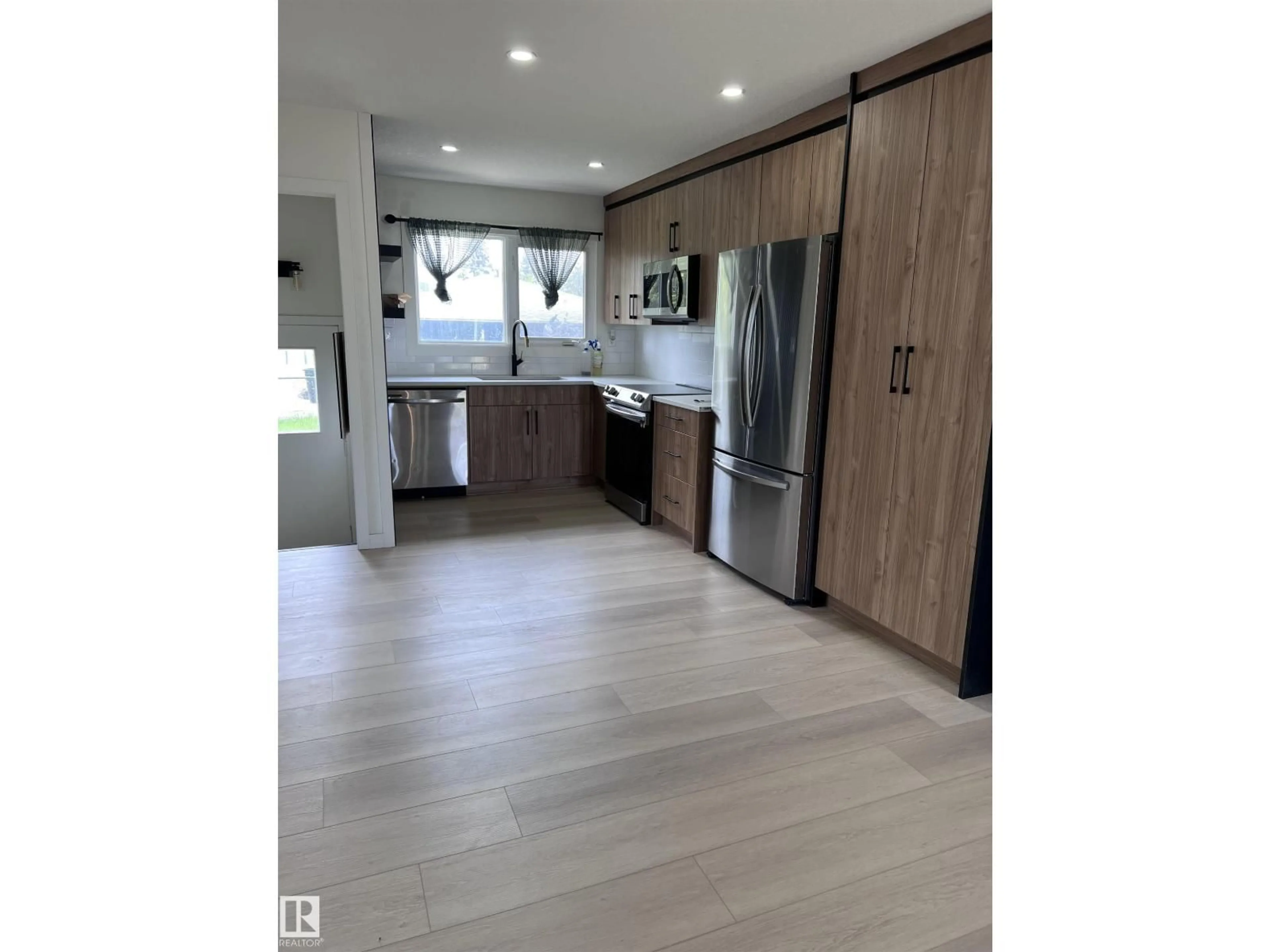 Open concept kitchen, wood/laminate floor for 11911 133 AV, Edmonton Alberta T5E1E8