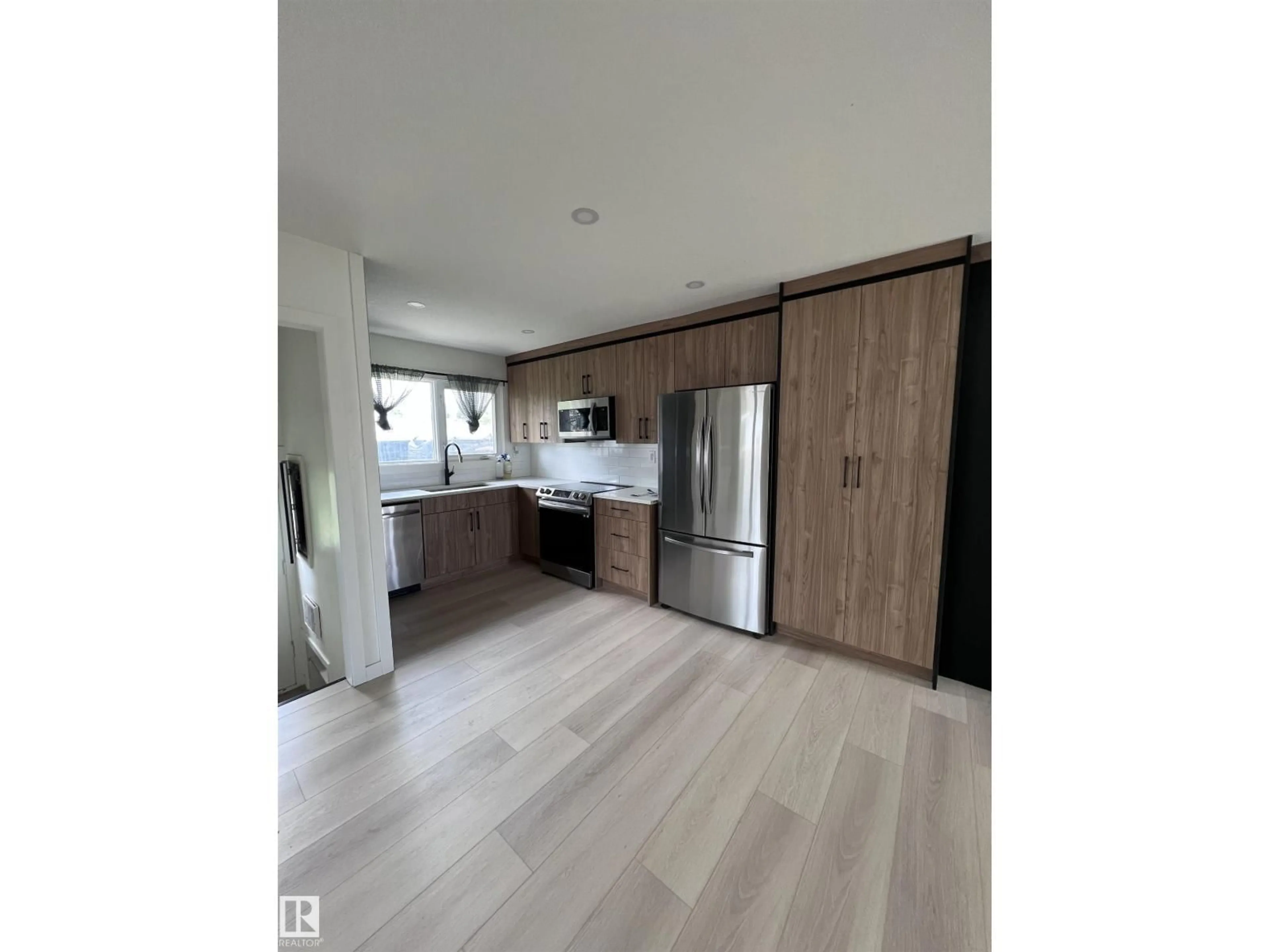 Open concept kitchen, wood/laminate floor for 11911 133 AV, Edmonton Alberta T5E1E8