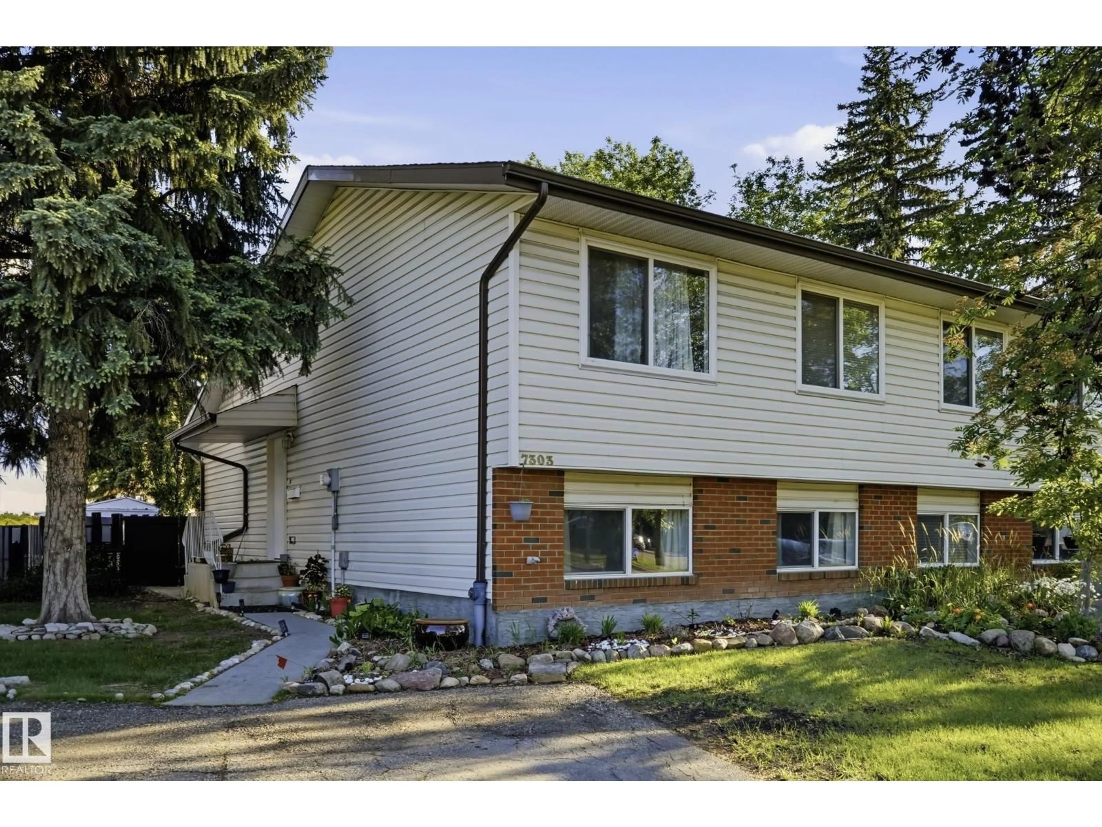 Home with vinyl exterior material, street for NW - 7303 180 ST, Edmonton Alberta T5T2T1
