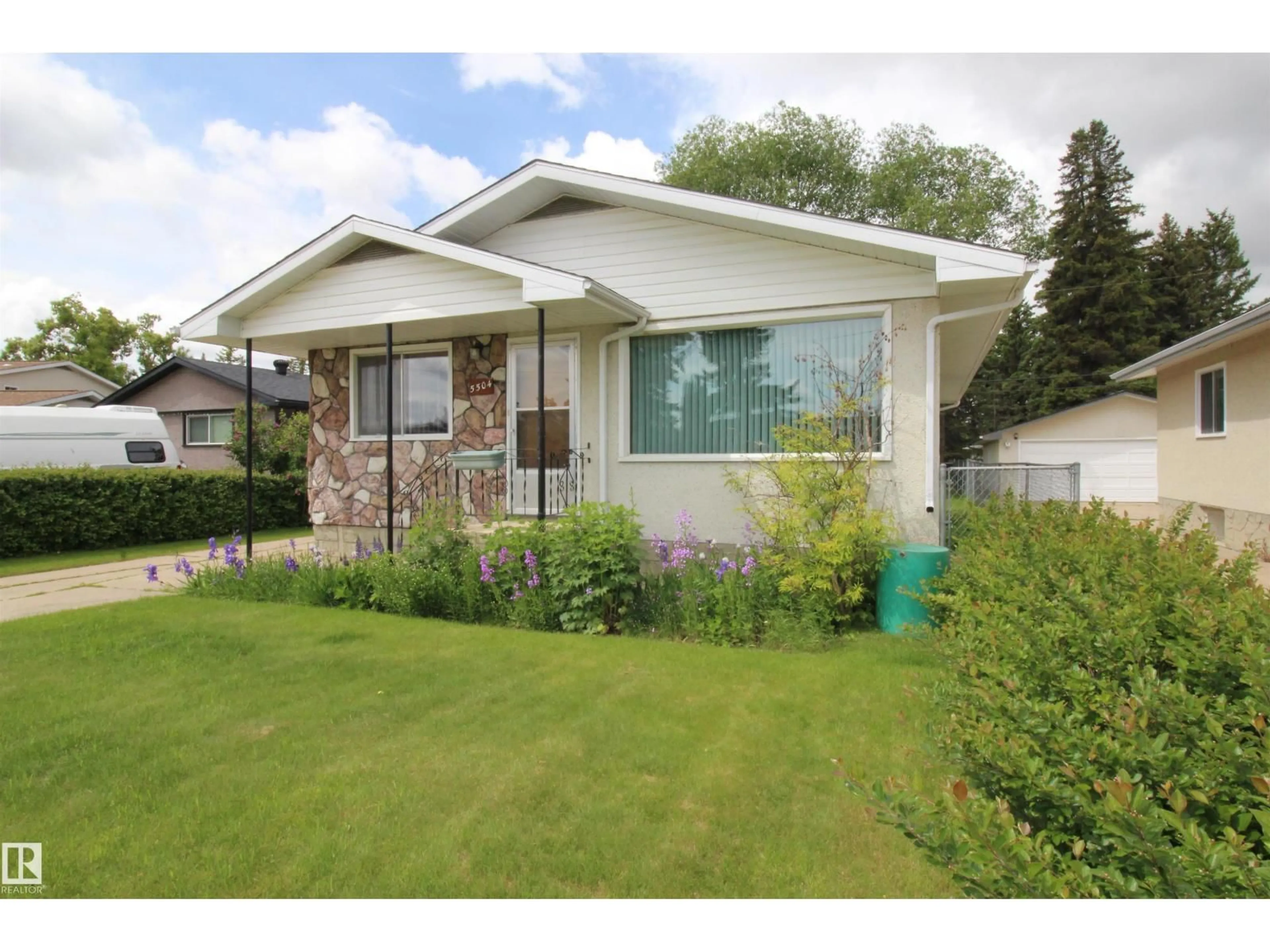 Home with vinyl exterior material, street for 5504 56, Barrhead Alberta T7N0A1