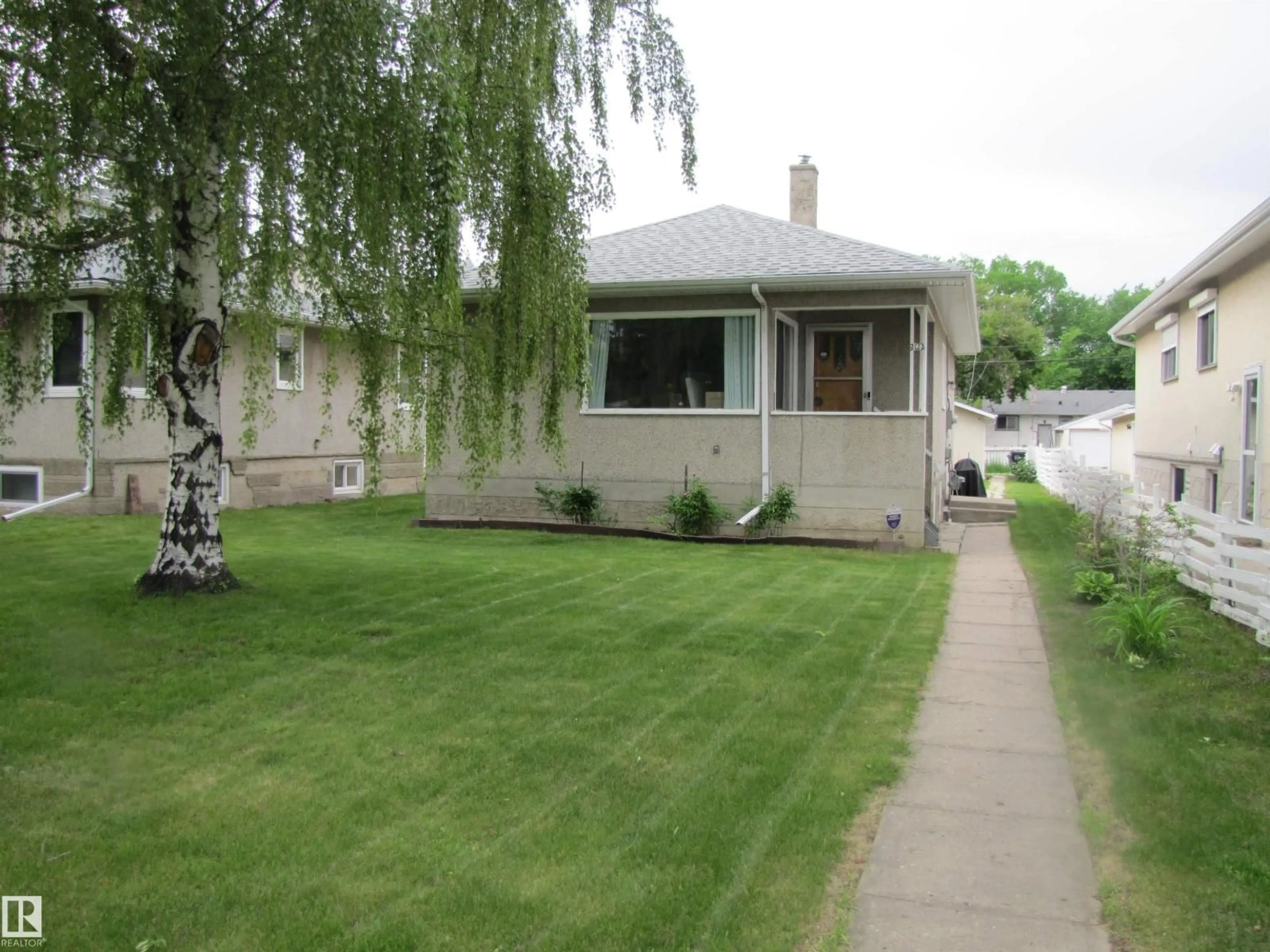 Home with vinyl exterior material, street for 8122 83 AV, Edmonton Alberta T6C1A8