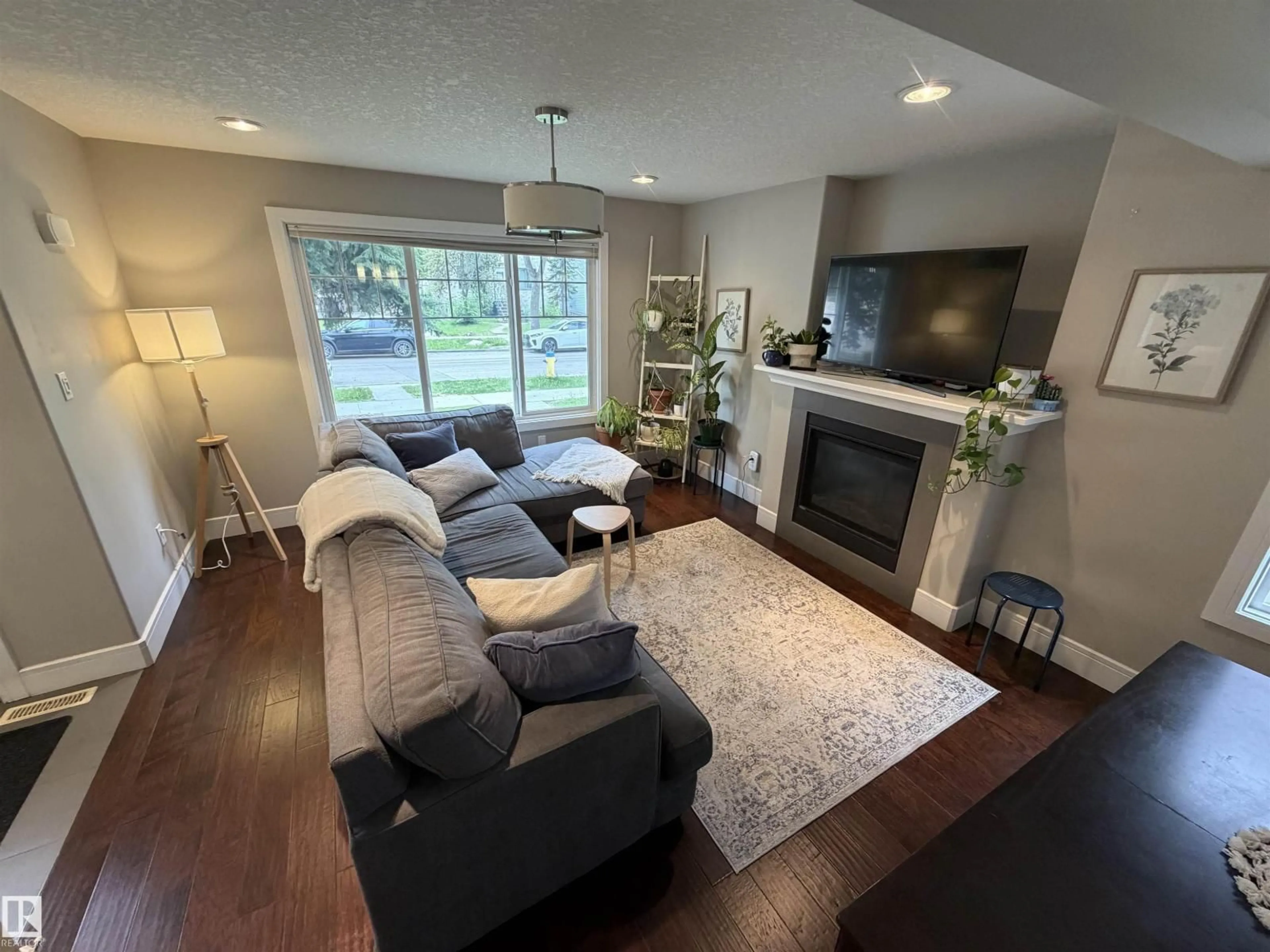 Living room with furniture, wood/laminate floor for 10914 71 AV, Edmonton Alberta T6G0A1