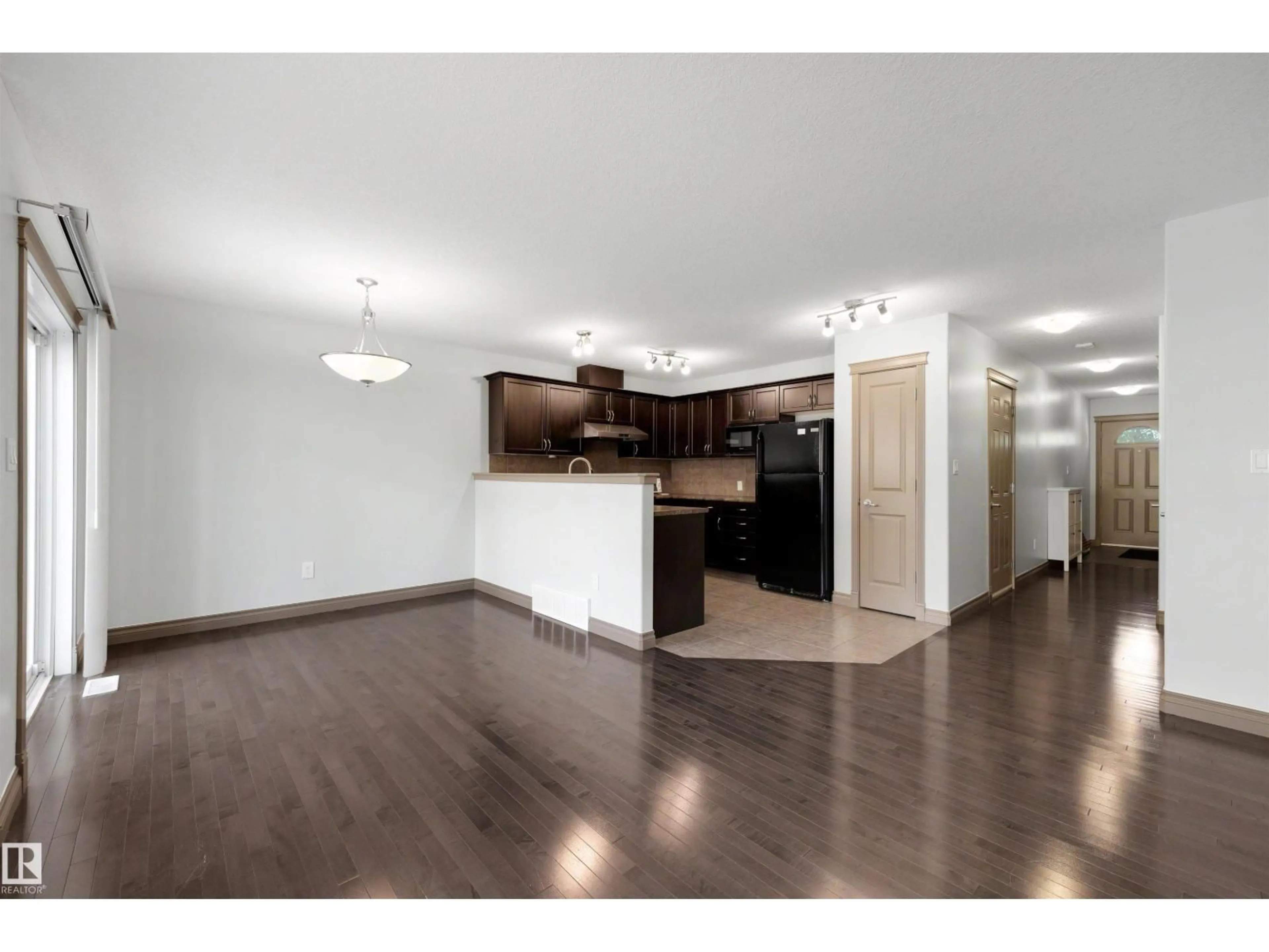 Open concept kitchen, wood/laminate floor for #21 - 5120 164 AV, Edmonton Alberta T5Y0L7