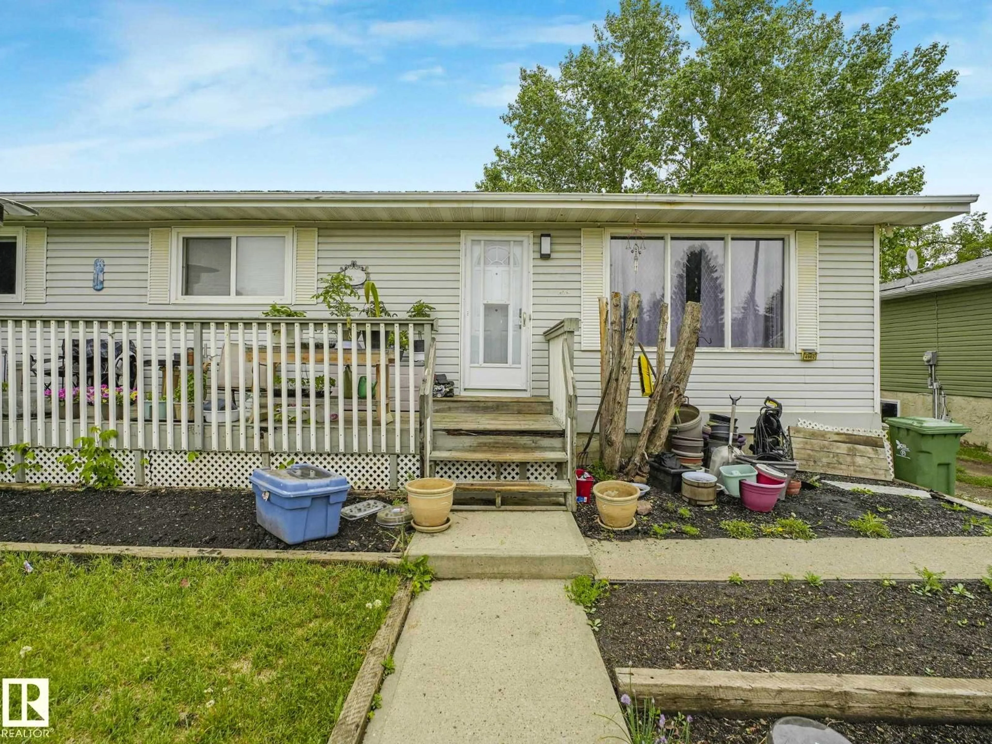 Home with vinyl exterior material, street for 4902 52 AV, Beaumont Alberta T4X1H6