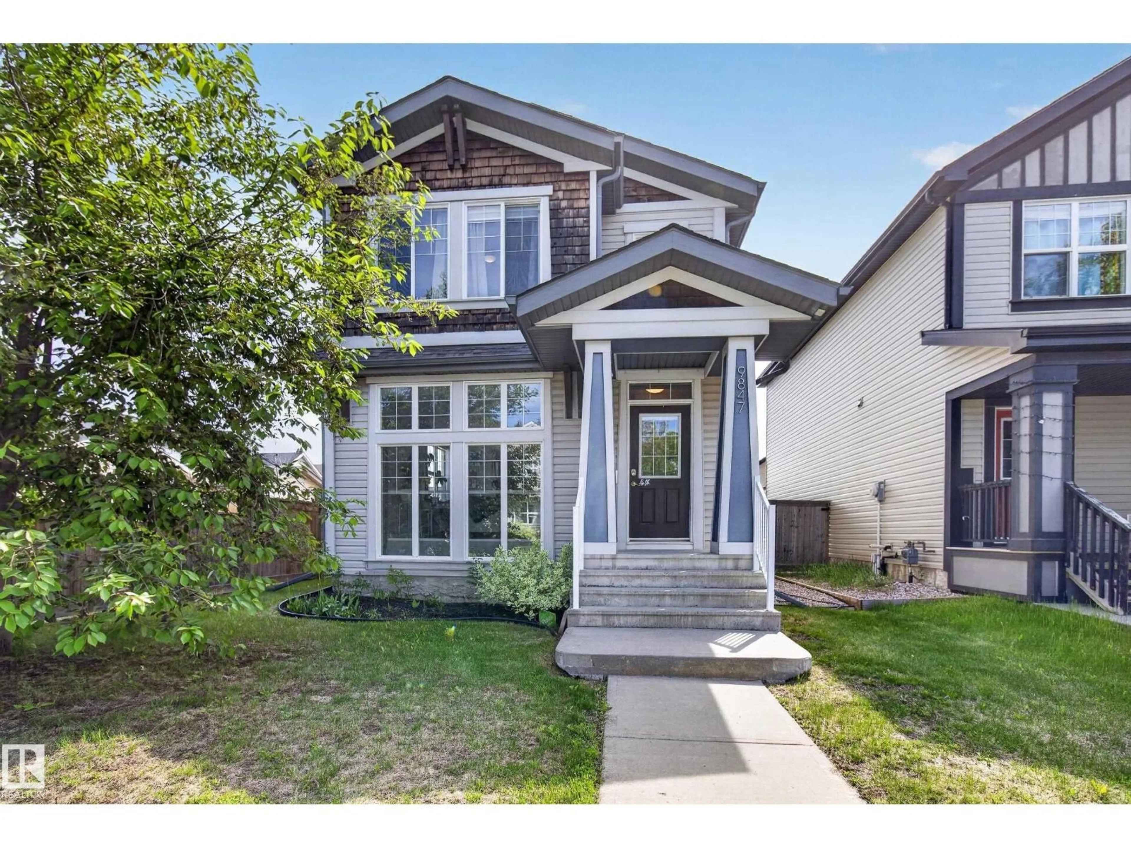 Home with vinyl exterior material, street for 9847 220 ST, Edmonton Alberta T5T4M3