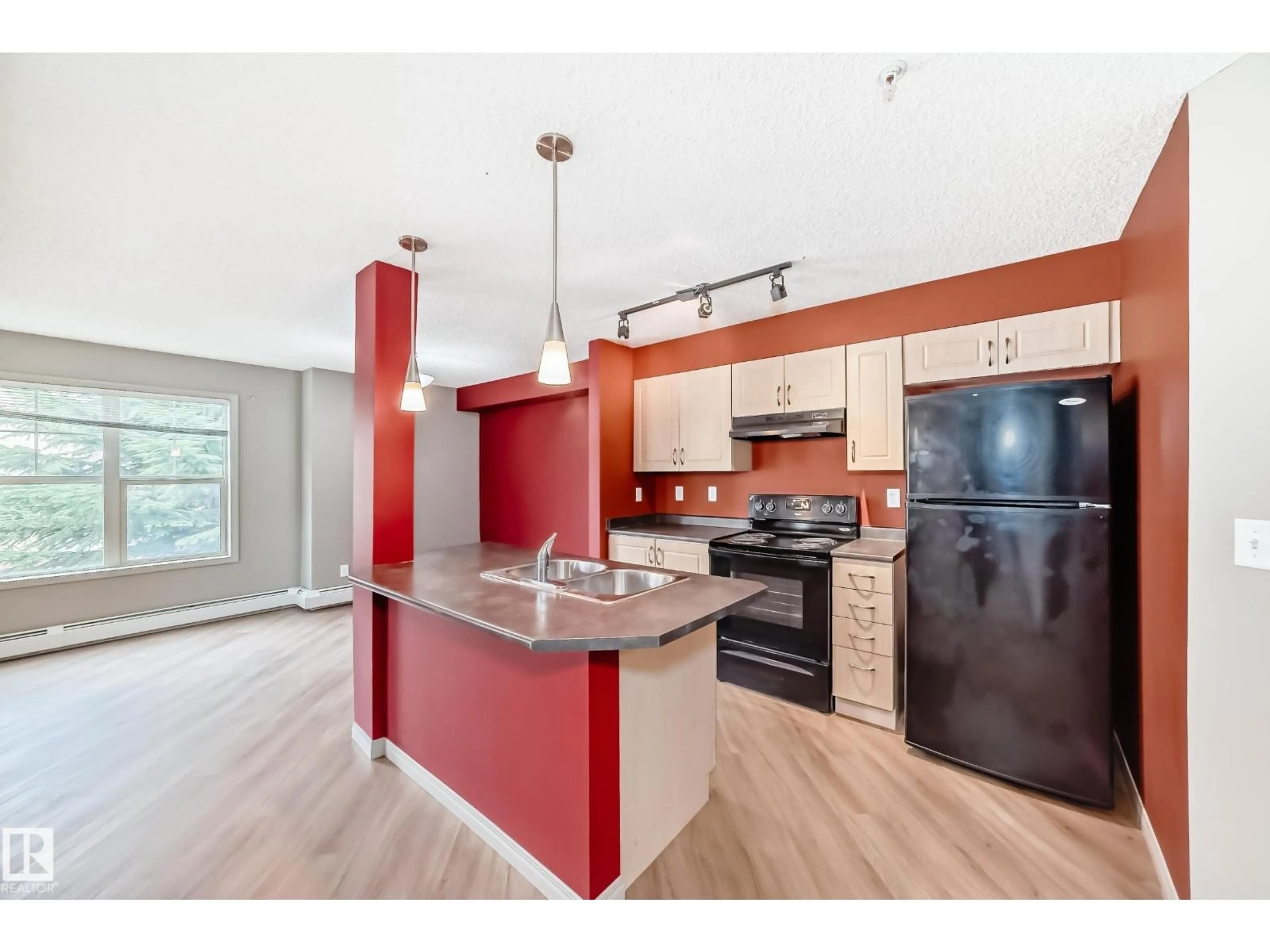 Open concept kitchen, wood/laminate floor for #211 - 11441 ELLERSLIE RD SW, Edmonton Alberta T6W1S9