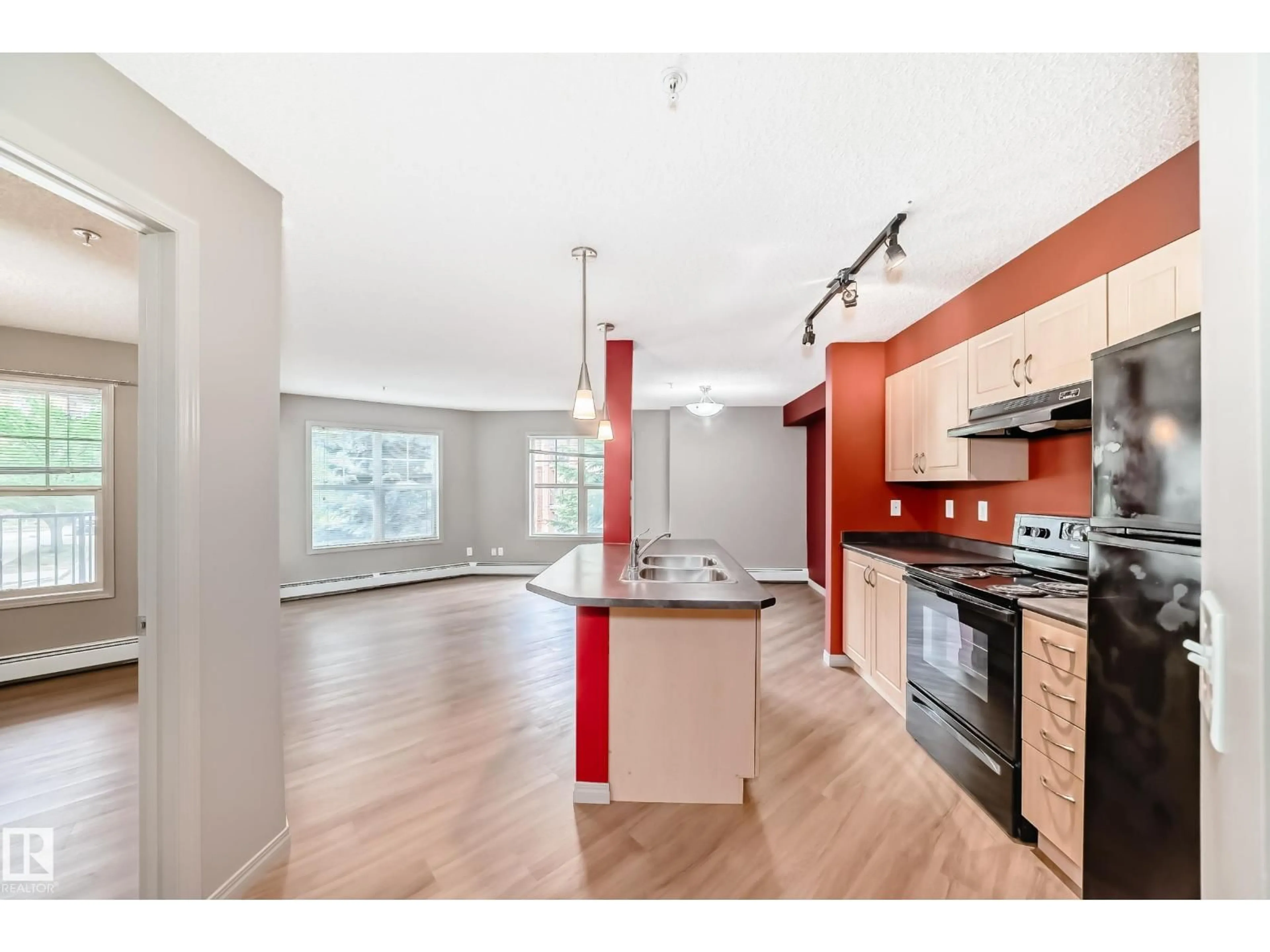 Open concept kitchen, wood/laminate floor for #211 - 11441 ELLERSLIE RD SW, Edmonton Alberta T6W1S9