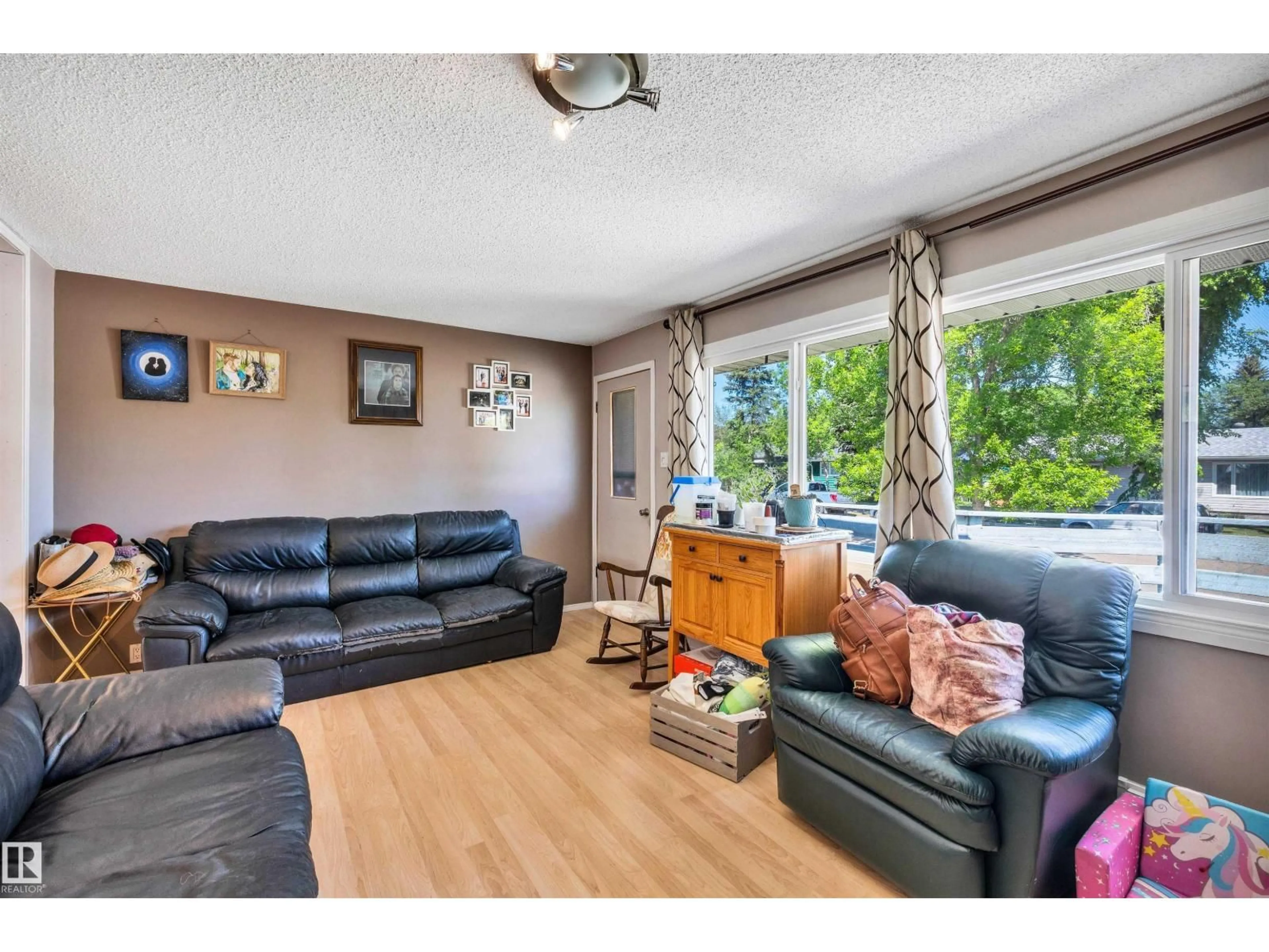 Living room with furniture, wood/laminate floor for 3619 110 AV, Edmonton Alberta T5W0H6