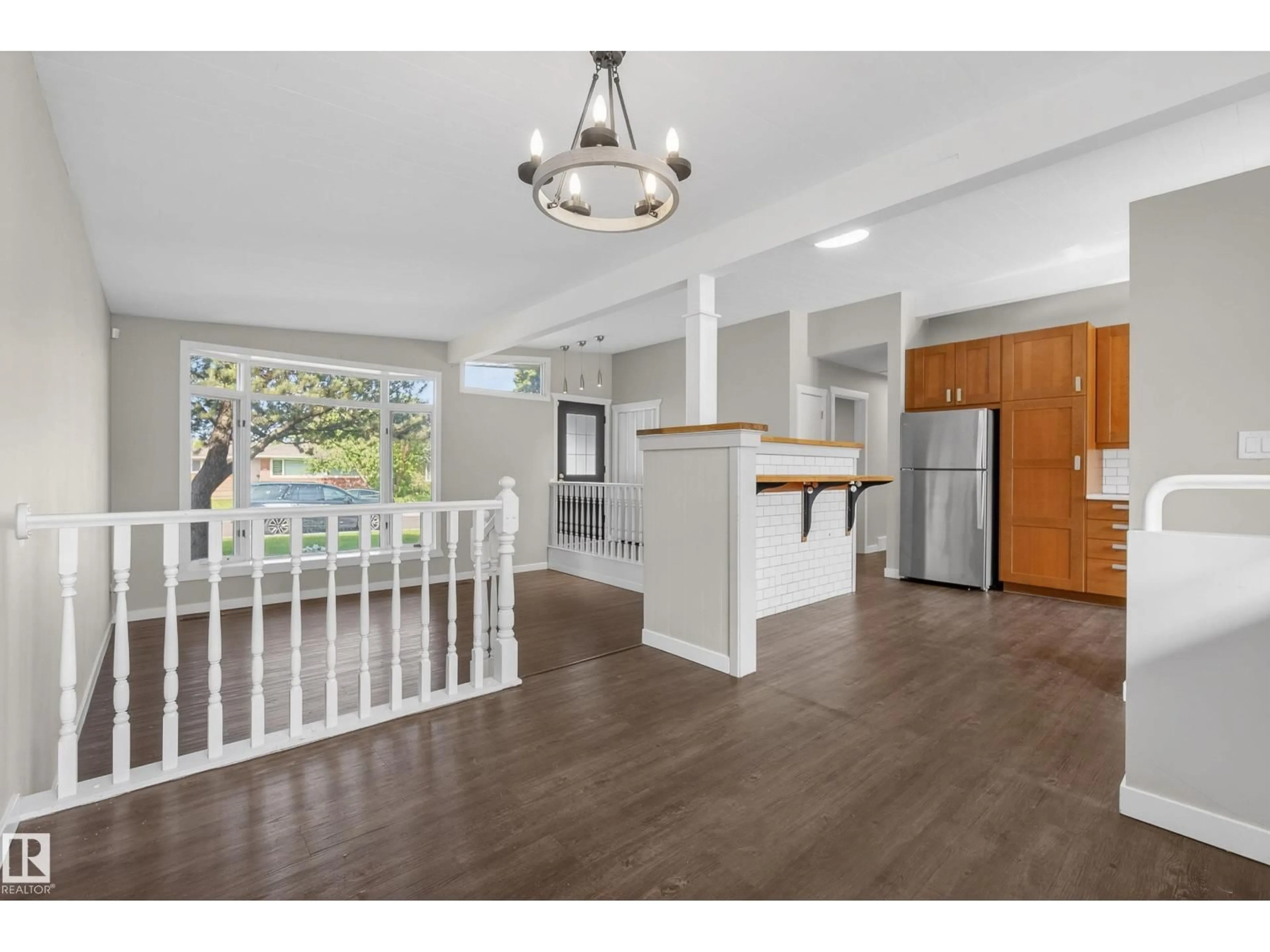 Open concept kitchen, wood/laminate floor for 9043 52 ST, Edmonton Alberta T6B1G1