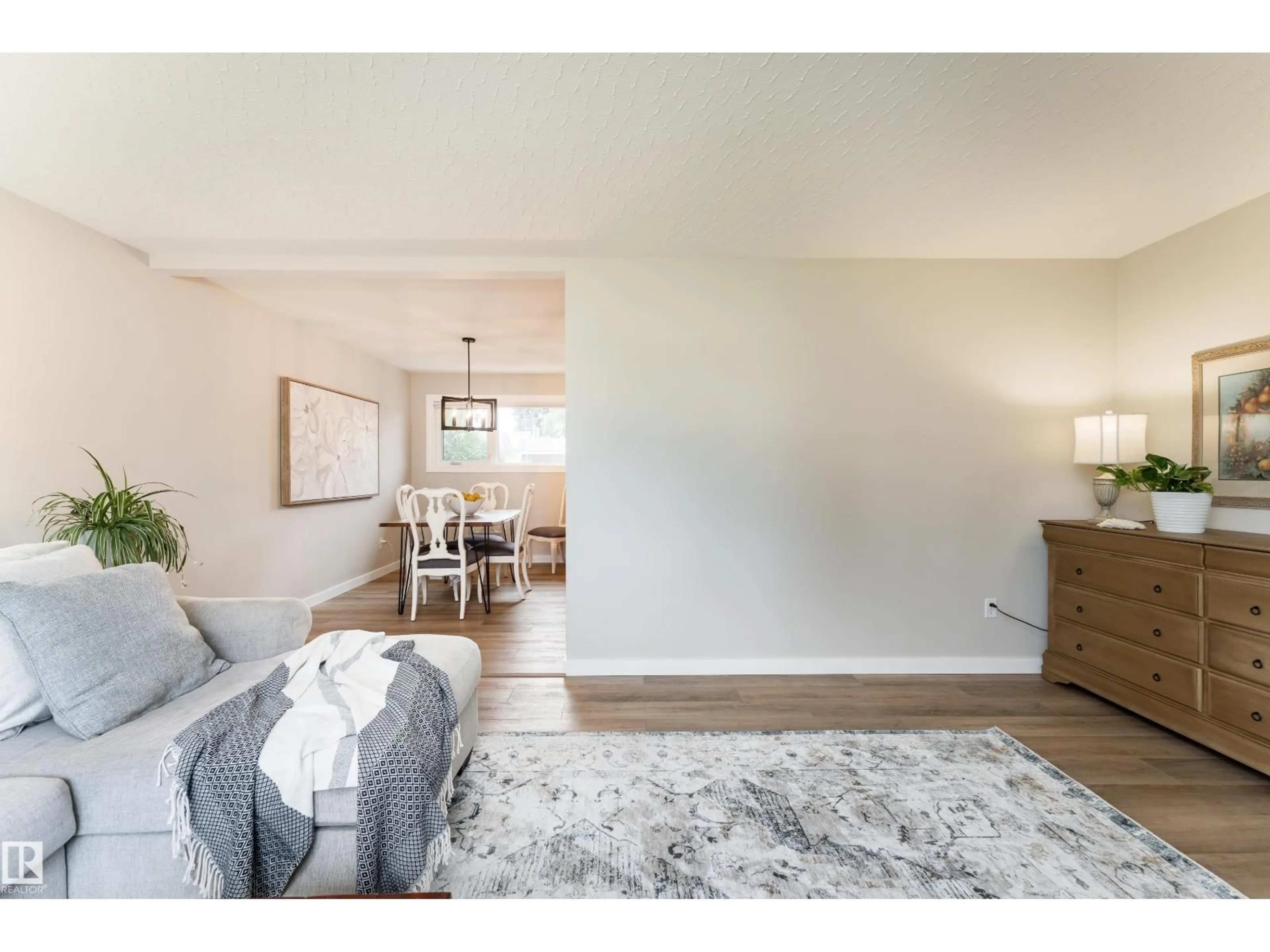 Living room with furniture, wood/laminate floor for 7223 95 AV, Edmonton Alberta T6B1B1