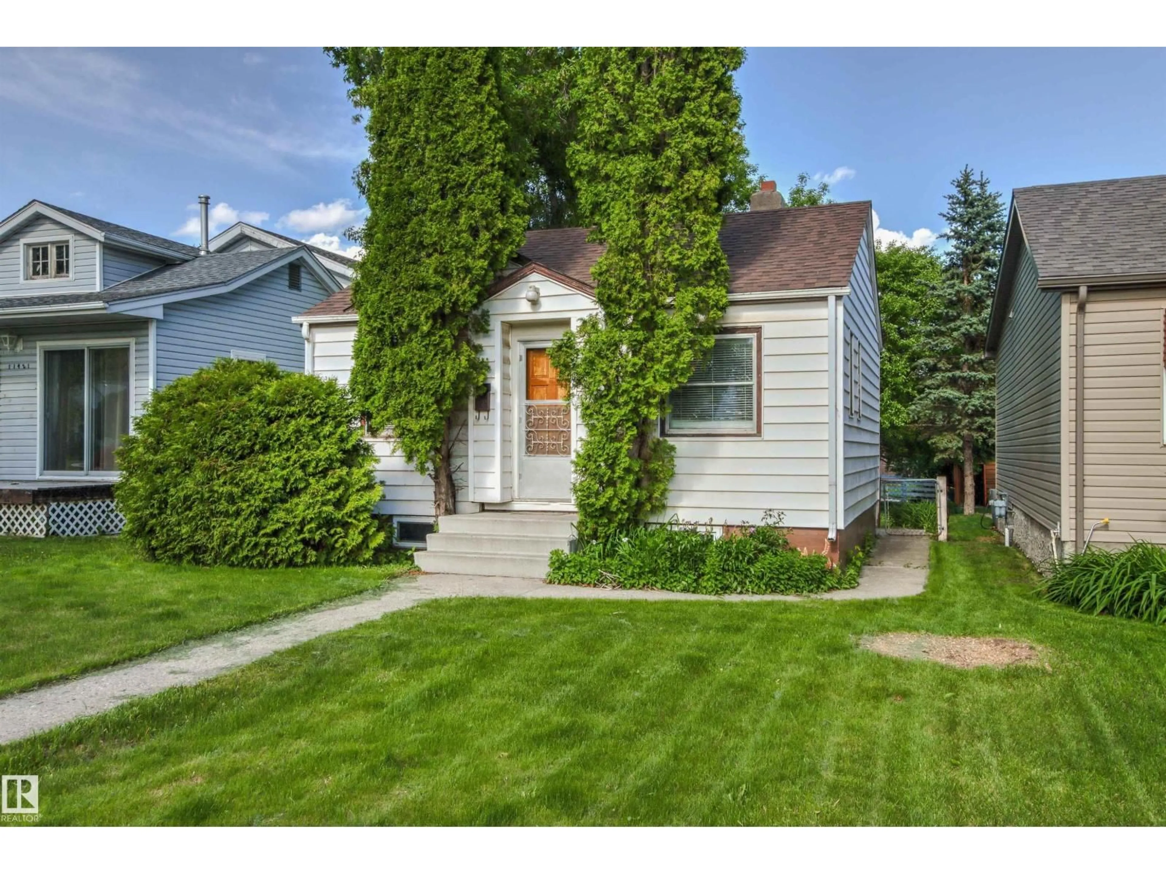 Home with vinyl exterior material, street for NW - 11417 65 ST, Edmonton Alberta T5W4K7