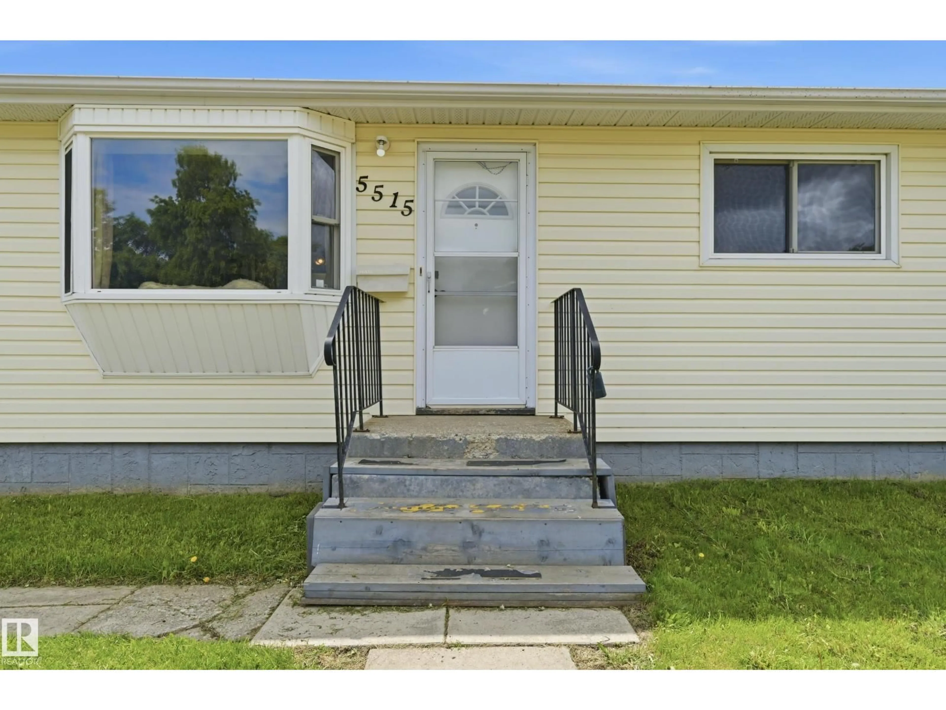 Home with vinyl exterior material, street for 5515 143 AV, Edmonton Alberta T5A1J9