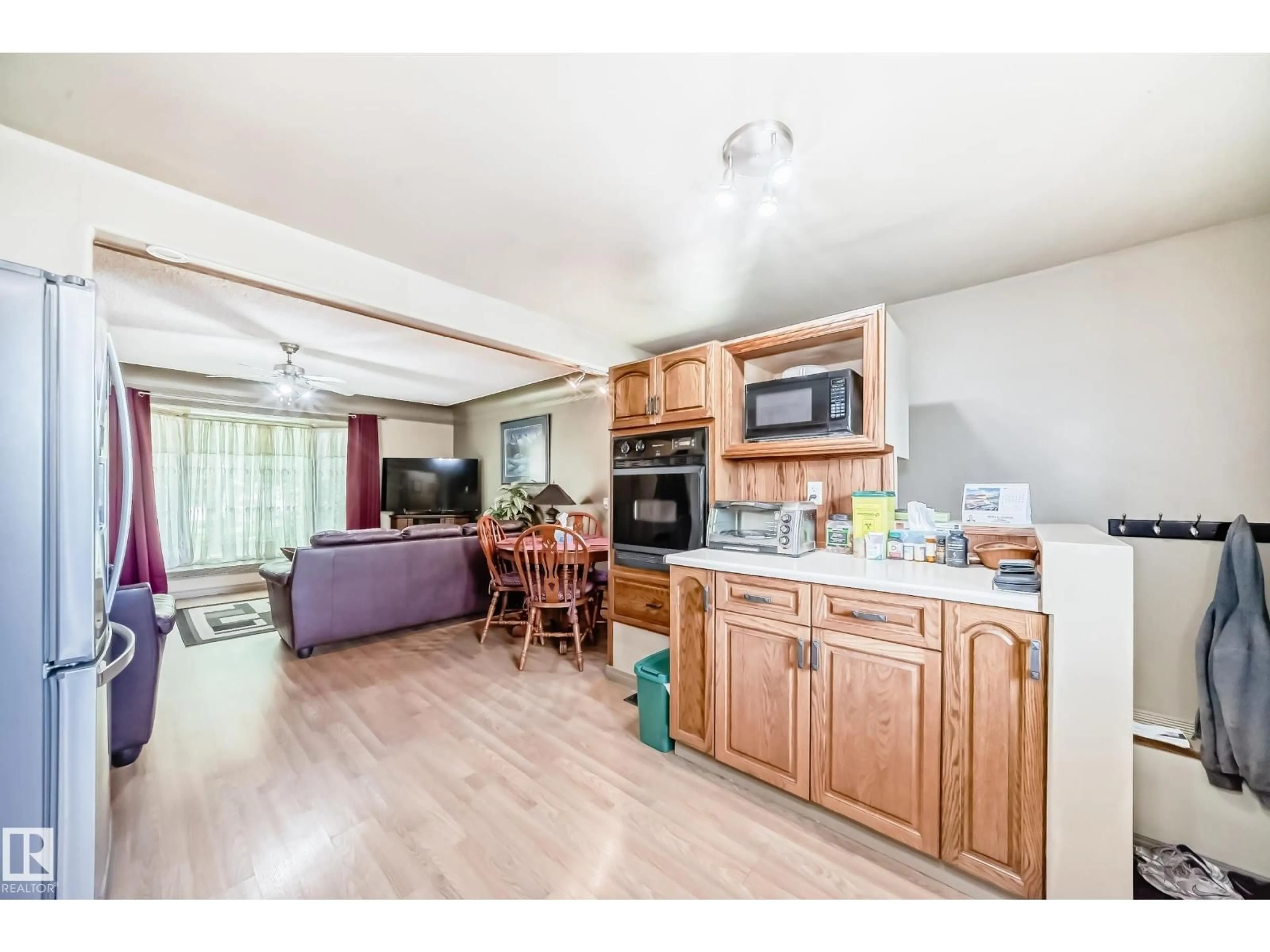 Open concept kitchen, wood/laminate floor for 12137 44 ST, Edmonton Alberta T5W2T2