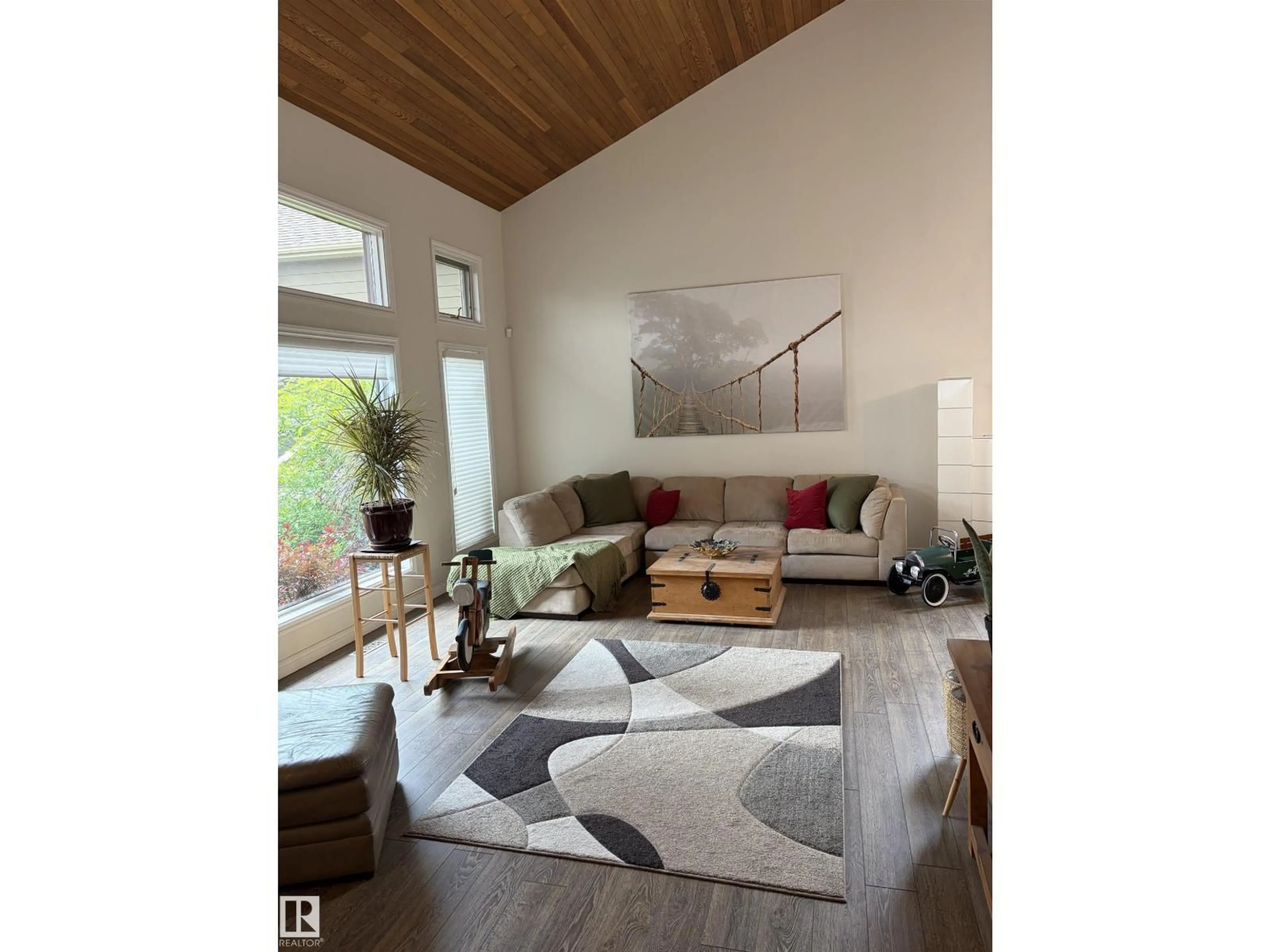 Living room with furniture, wood/laminate floor for 969 RICE RD, Edmonton Alberta T6R1B1