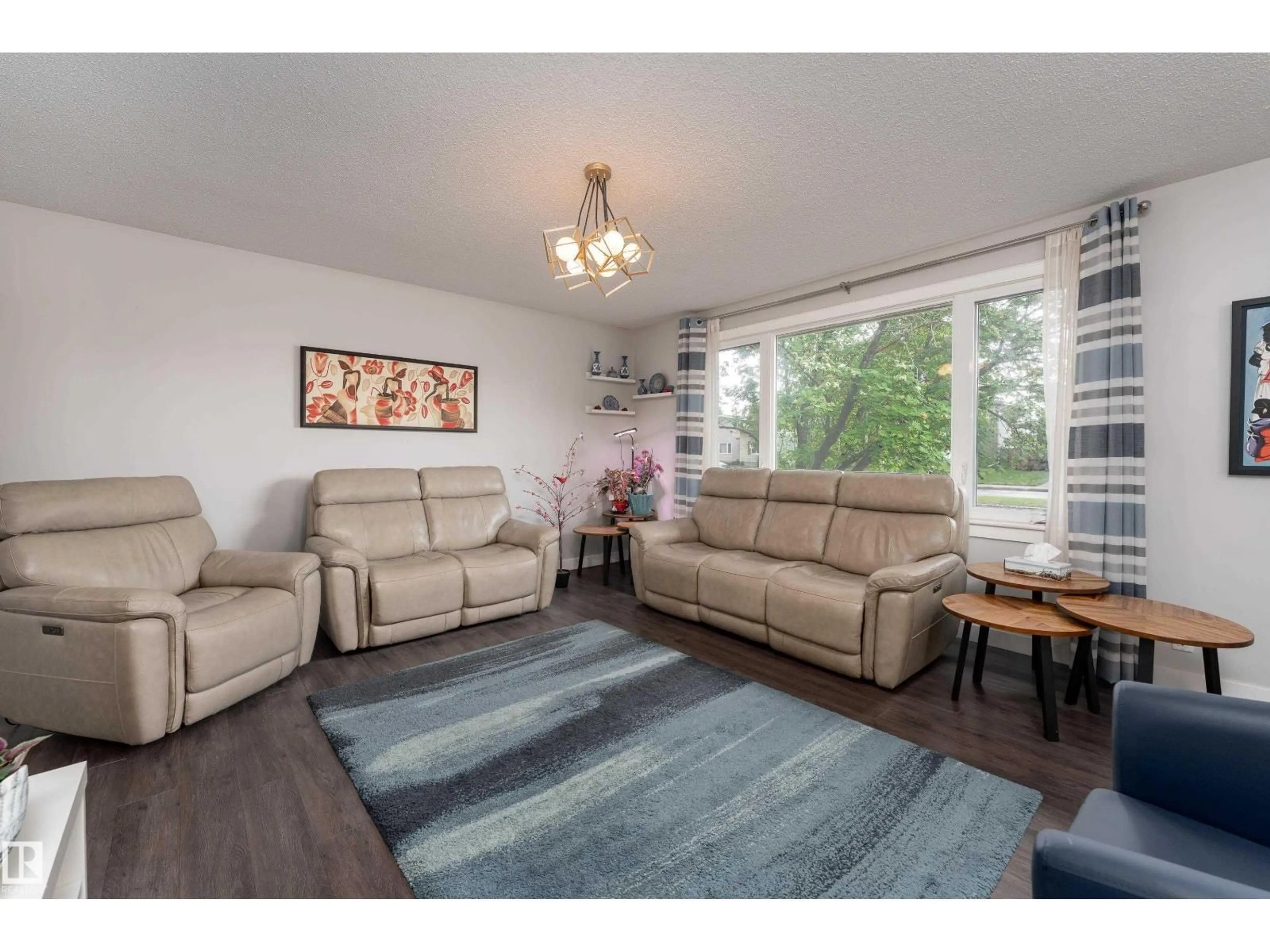 Living room with furniture, wood/laminate floor for 11227 40 AV, Edmonton Alberta T6J0P9