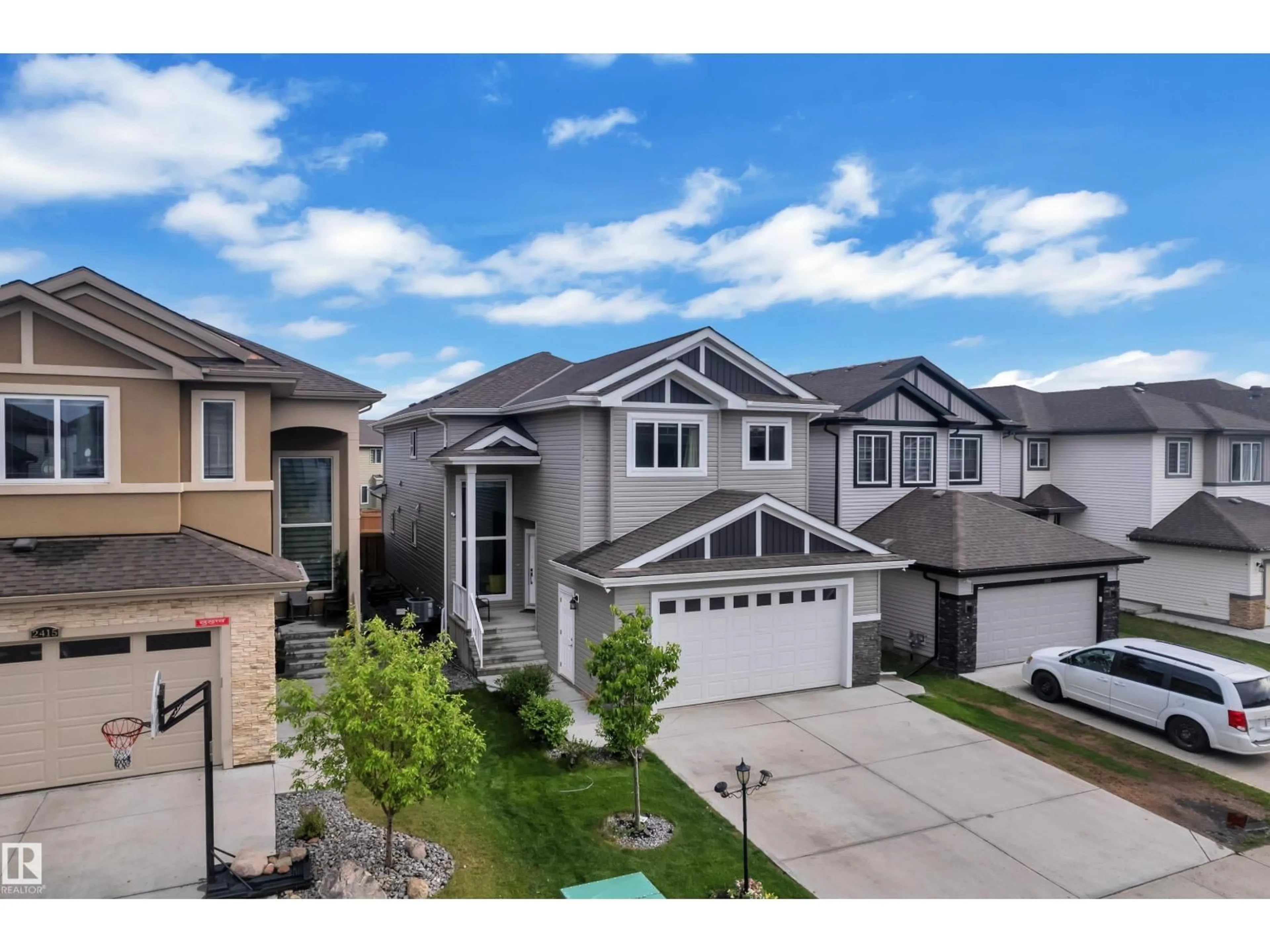 Home with vinyl exterior material, street for 2419 15 AV, Edmonton Alberta T6T2L3