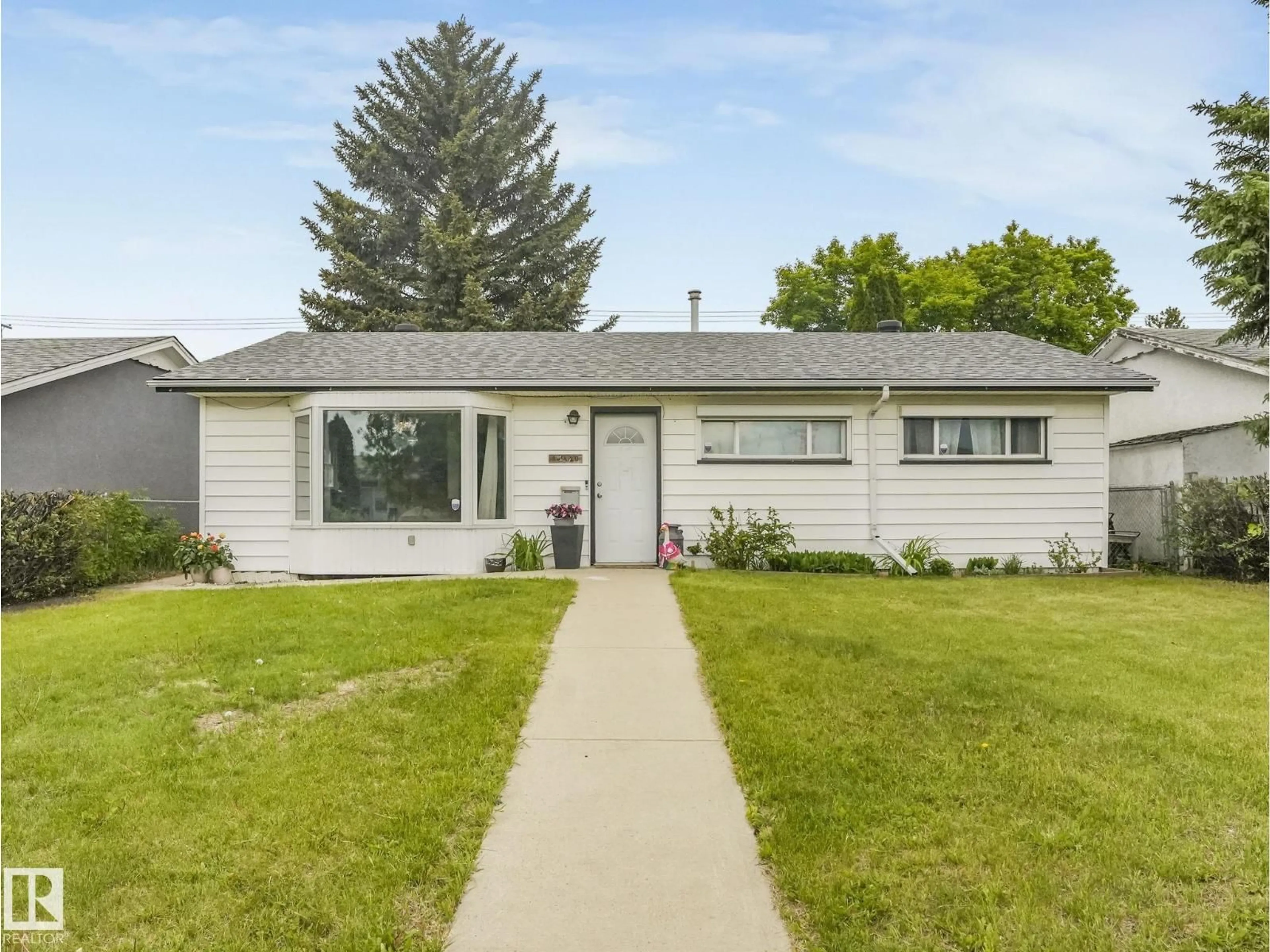 Home with vinyl exterior material, street for 13420 108 ST NW, Edmonton Alberta T5E4X6