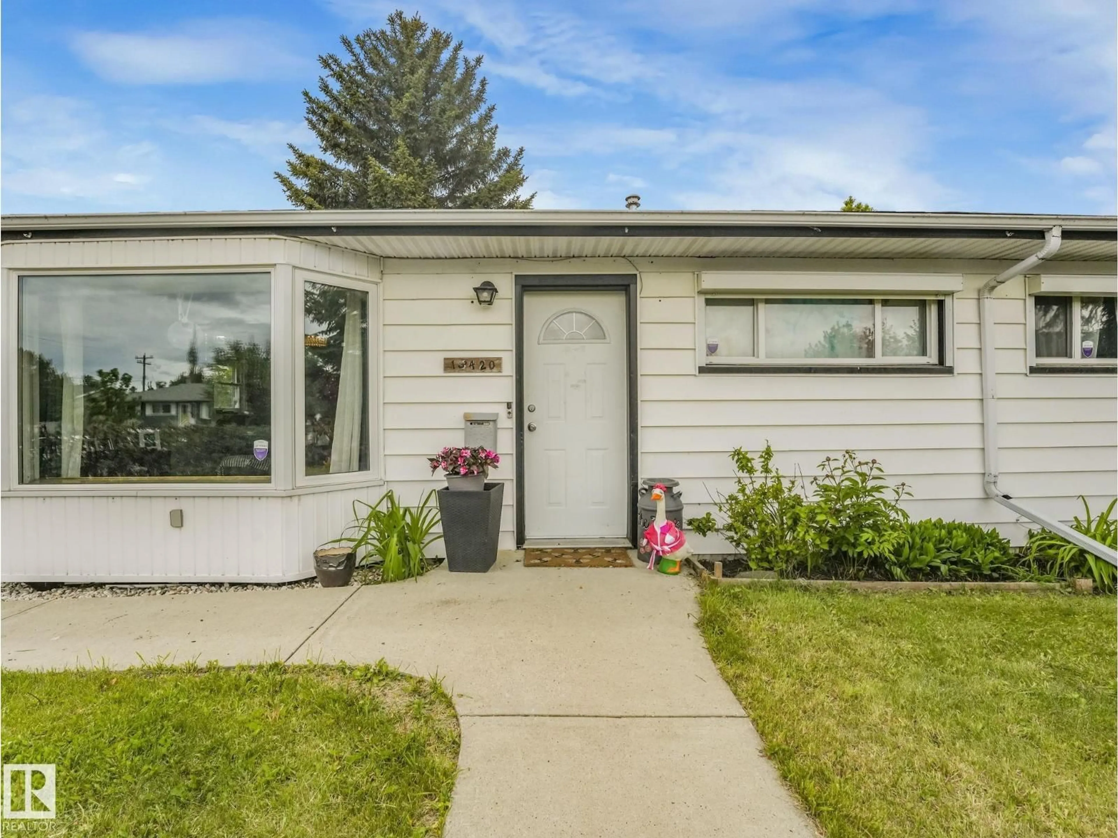 Home with vinyl exterior material, street for 13420 108 ST NW, Edmonton Alberta T5E4X6