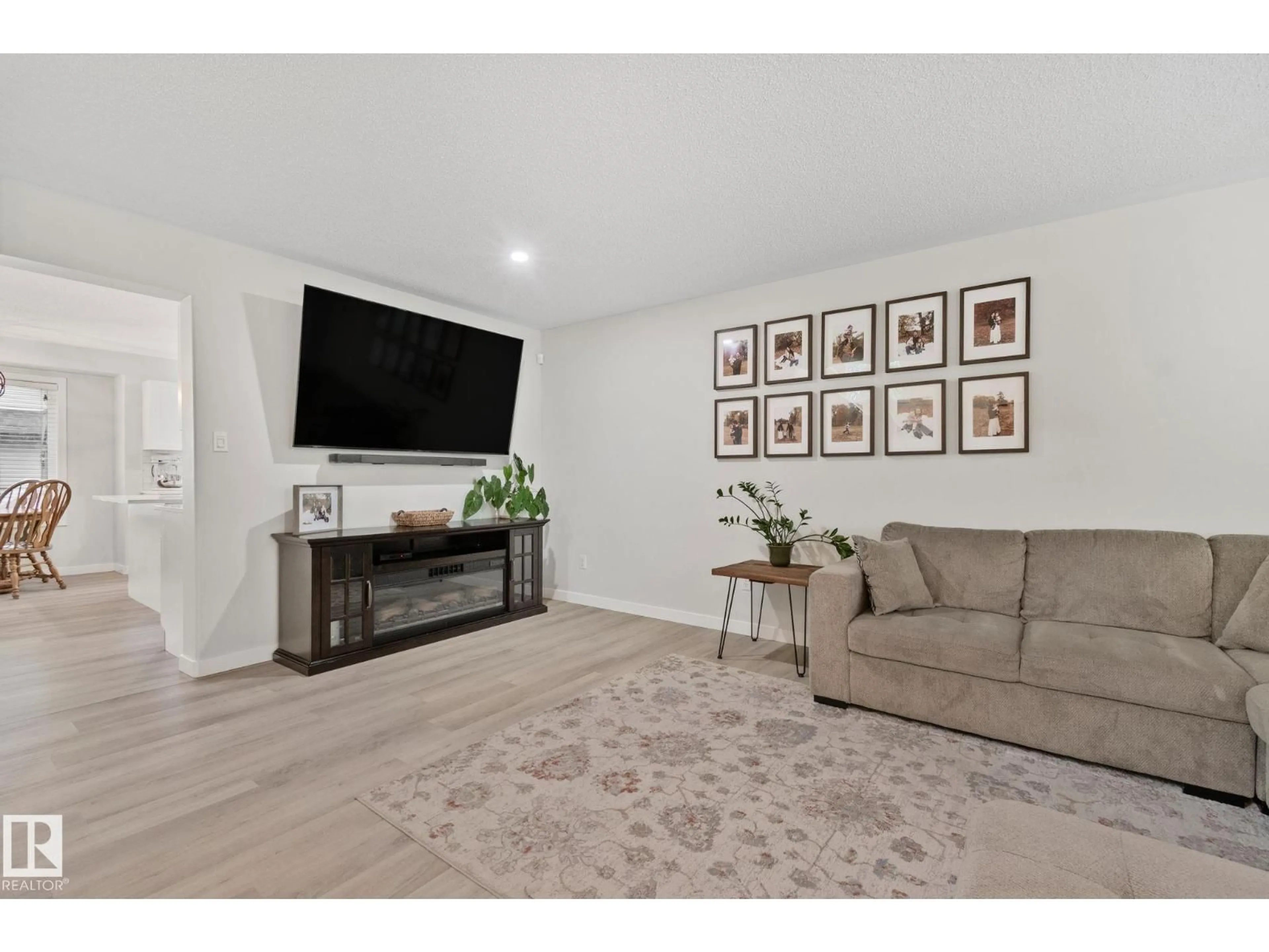 Living room with furniture, wood/laminate floor for 1604 TOMPKINS PL, Edmonton Alberta T6R2Y5