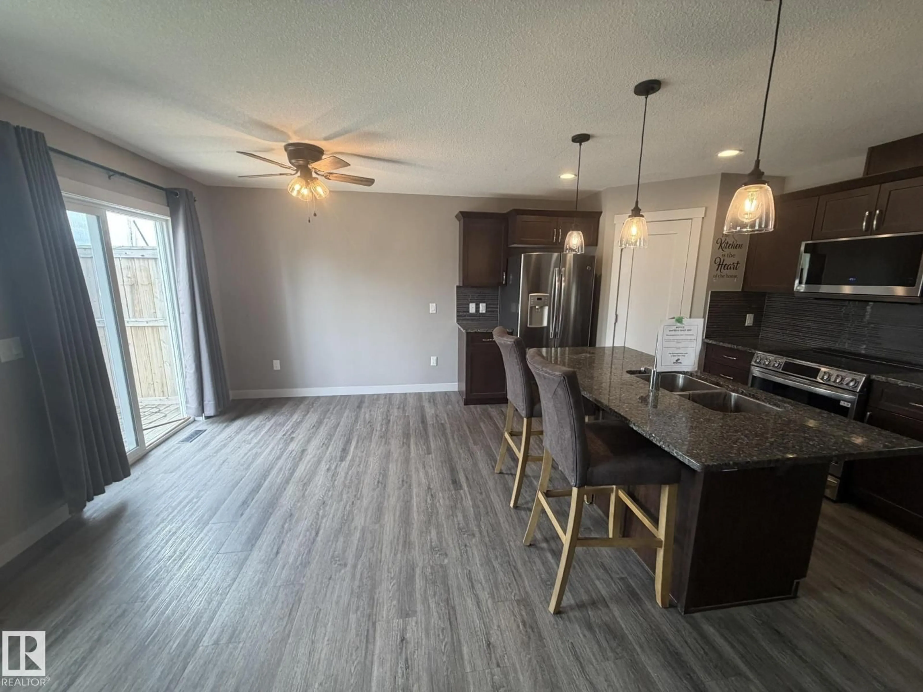 Open concept kitchen, wood/laminate floor for 6821 EVANS WD NW, Edmonton Alberta T6M0T3