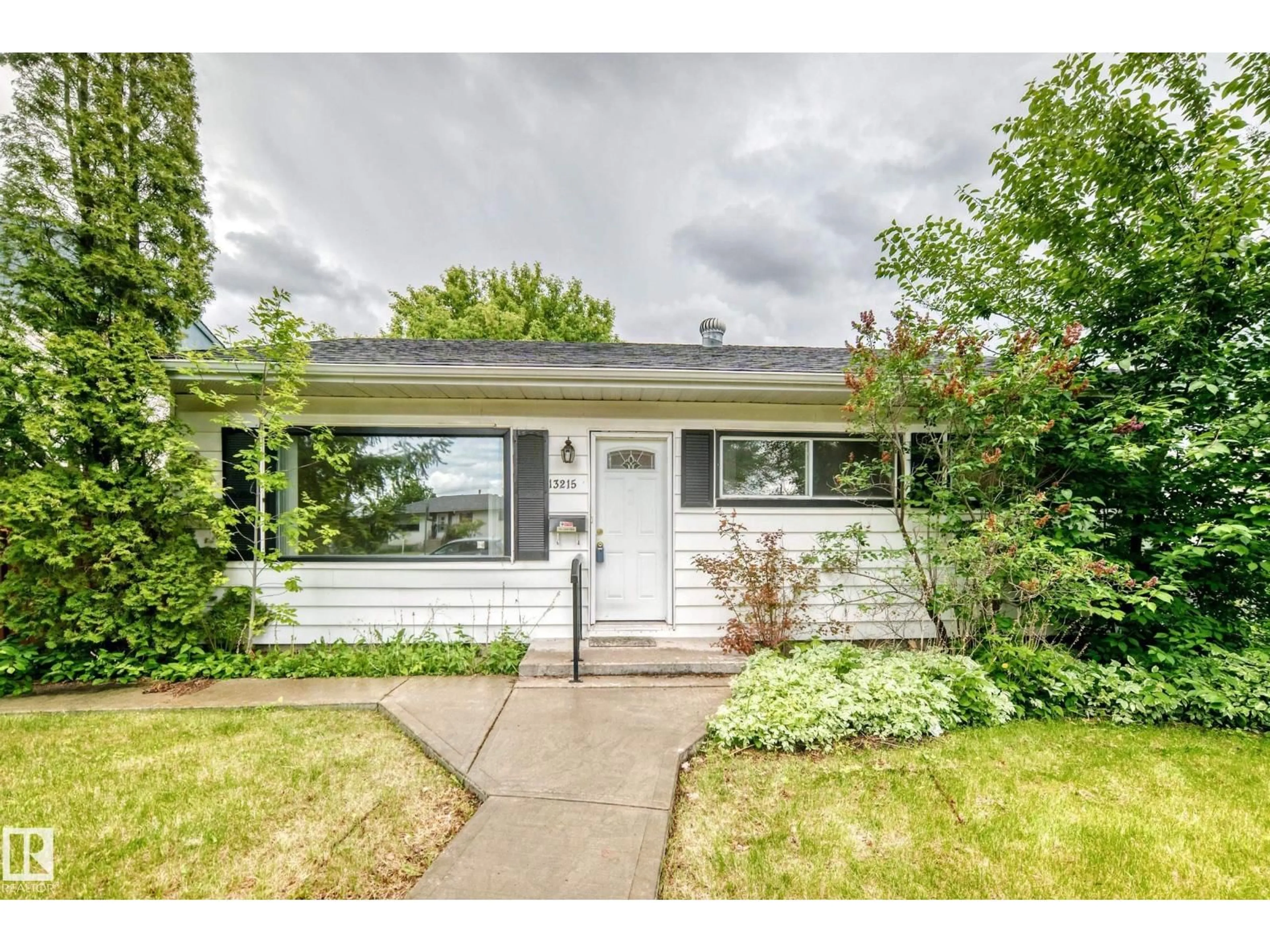 Home with vinyl exterior material, street for 13215 132 AV, Edmonton Alberta T5L3R4
