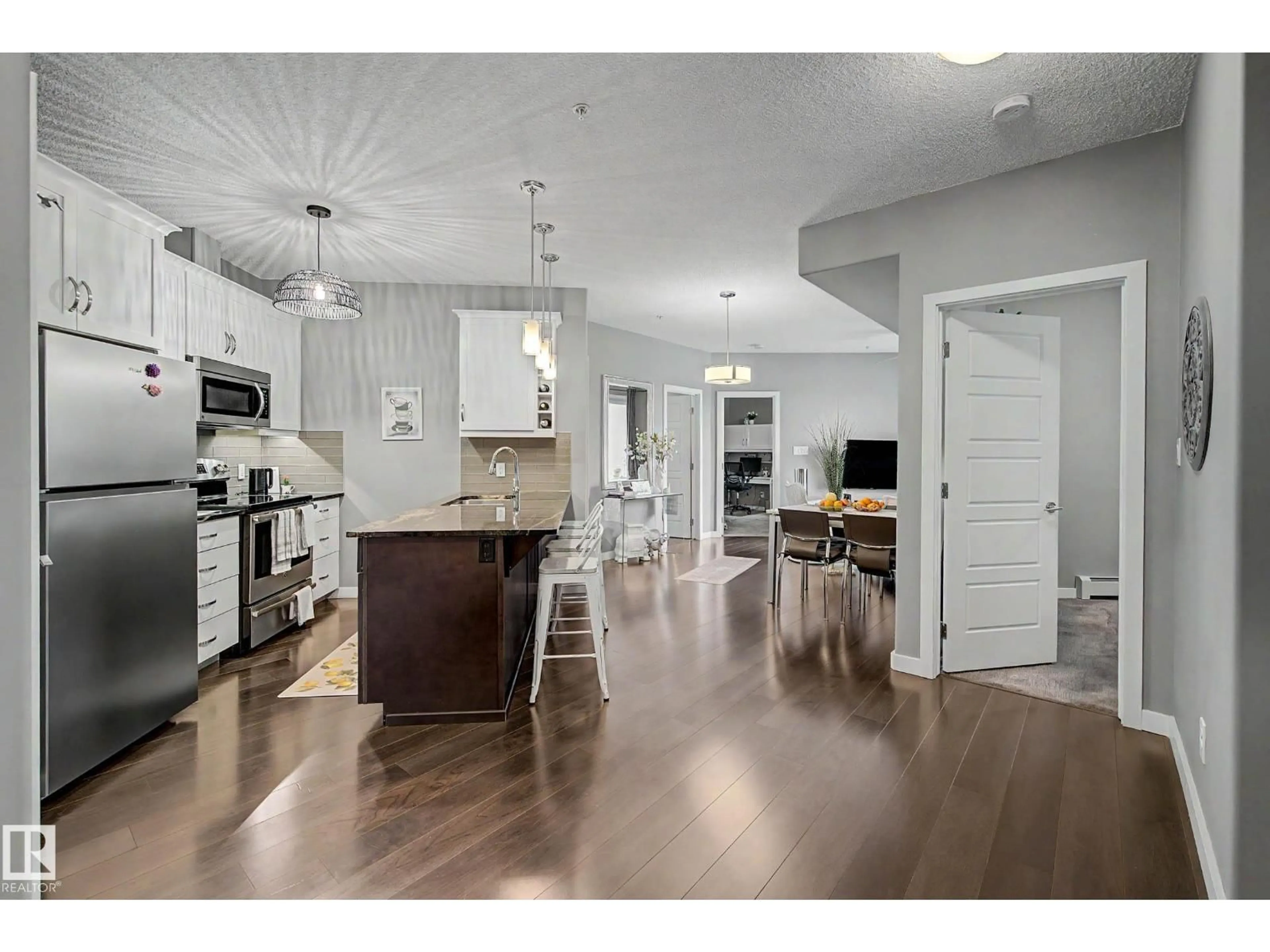 Open concept kitchen, wood/laminate floor for #410 - 1004 ROSENTHAL BV, Edmonton Alberta T5T7C6
