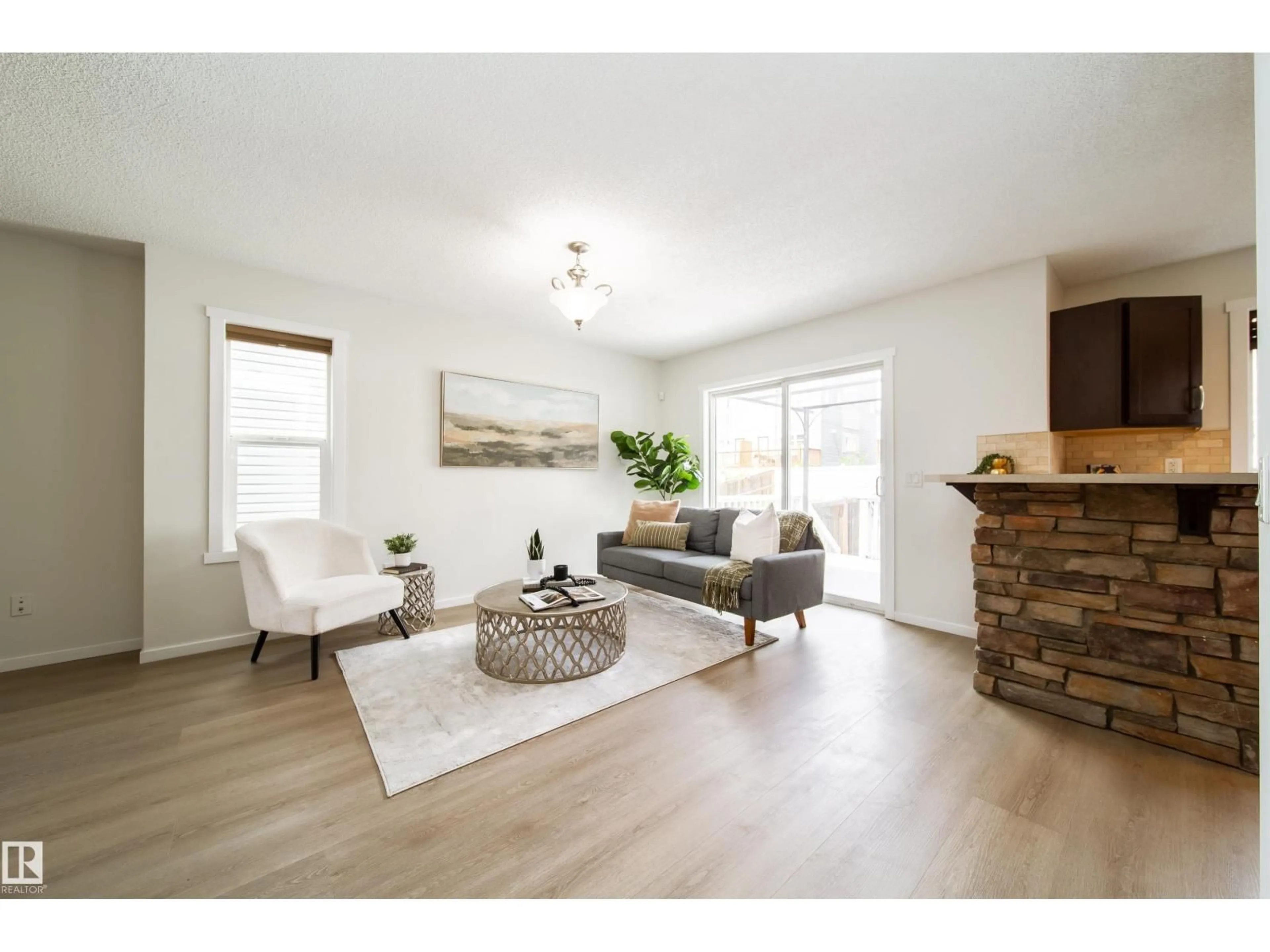 Living room with furniture, wood/laminate floor for 405 SIMMONDS WY, Leduc Alberta T9E0E6