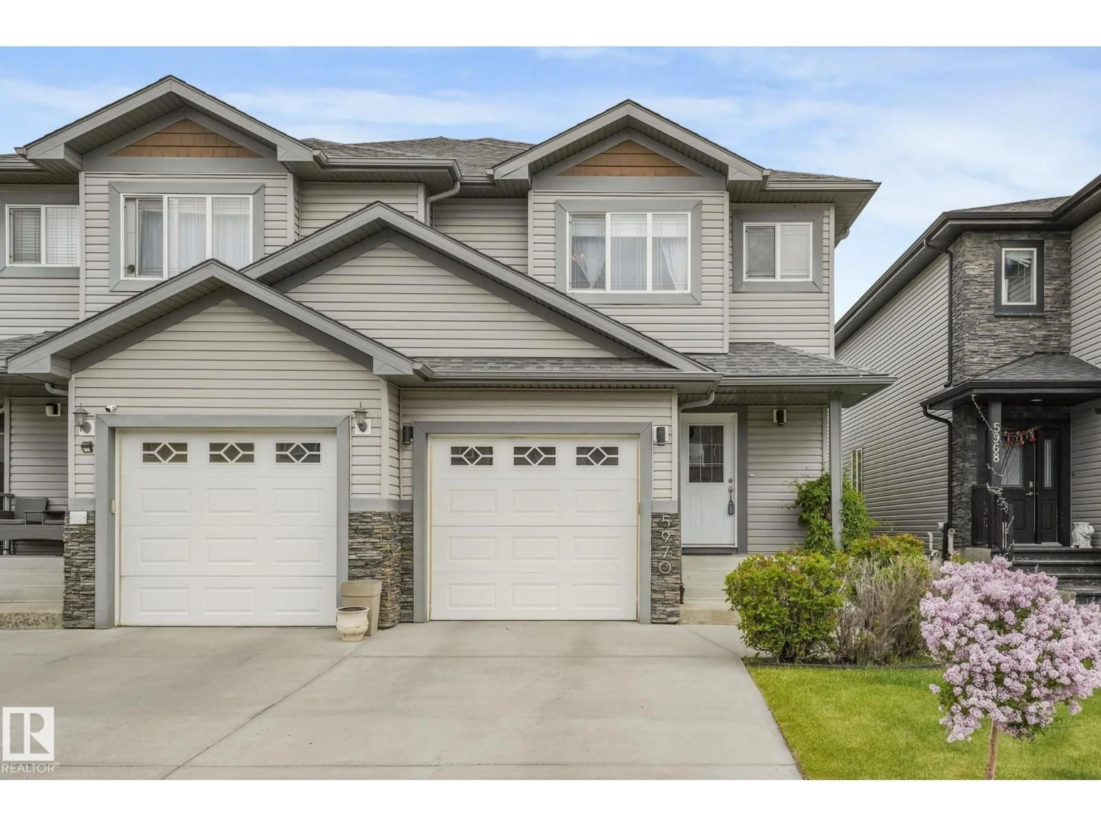 Home with vinyl exterior material, street for 5970 167C AV, Edmonton Alberta T5Y0W4
