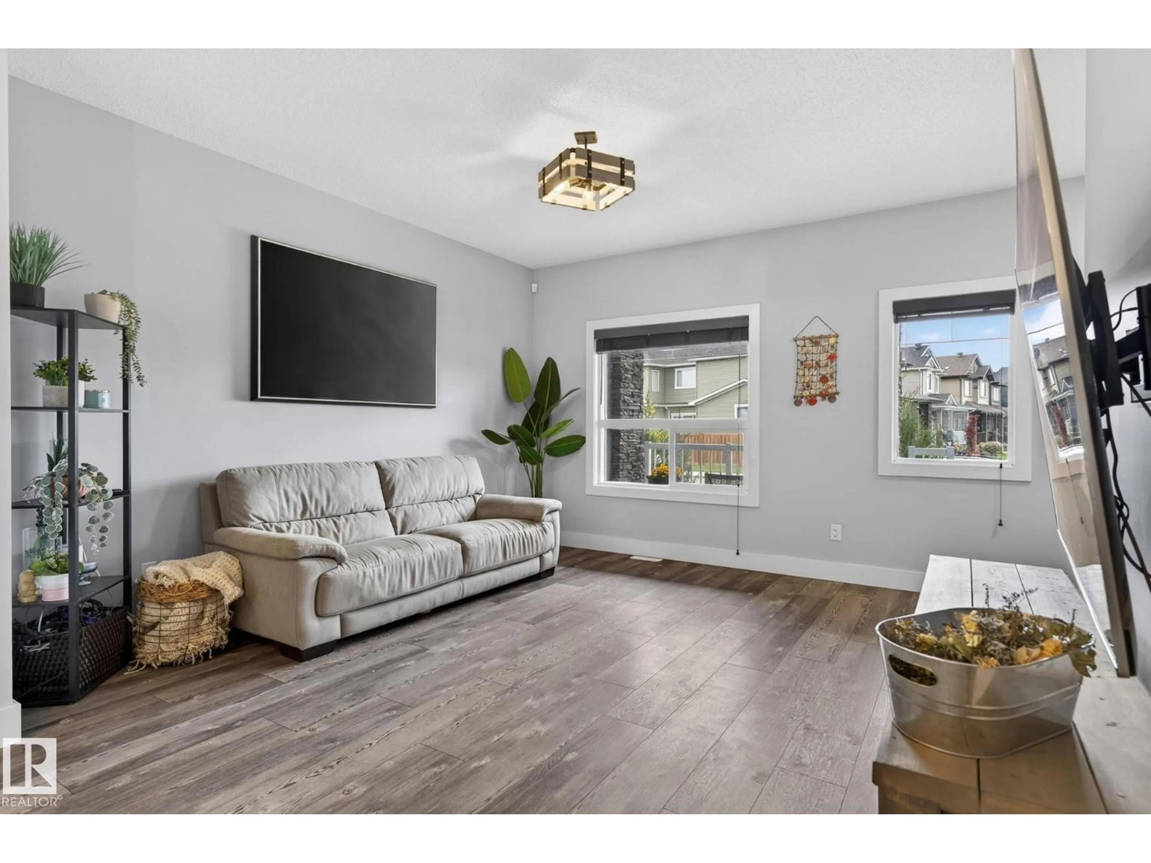 Living room with furniture, wood/laminate floor for 17733 64A ST, Edmonton Alberta T5Y3X4
