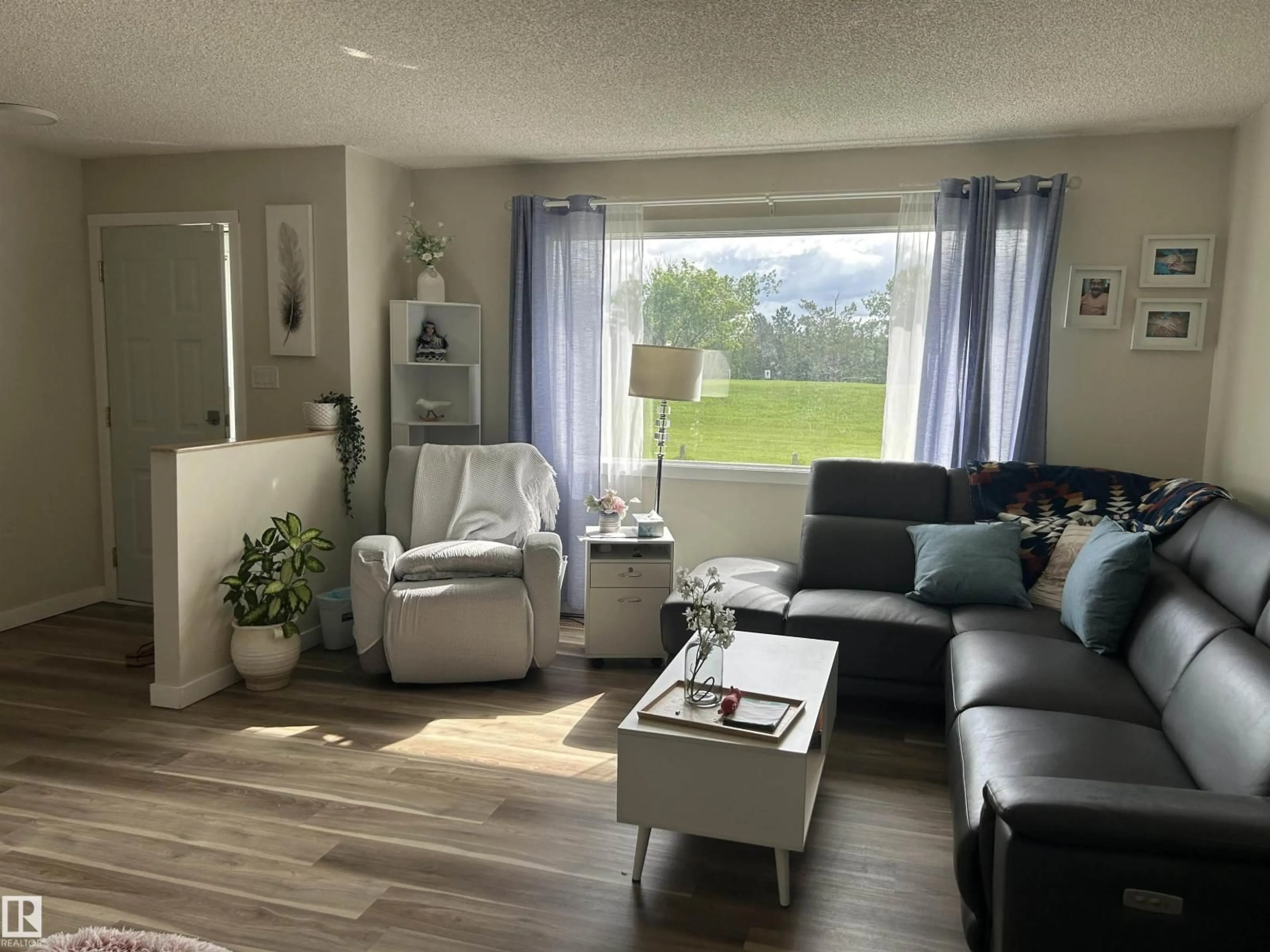 Living room with furniture, wood/laminate floor for 10924 30 ST, Edmonton Alberta T5W1V9