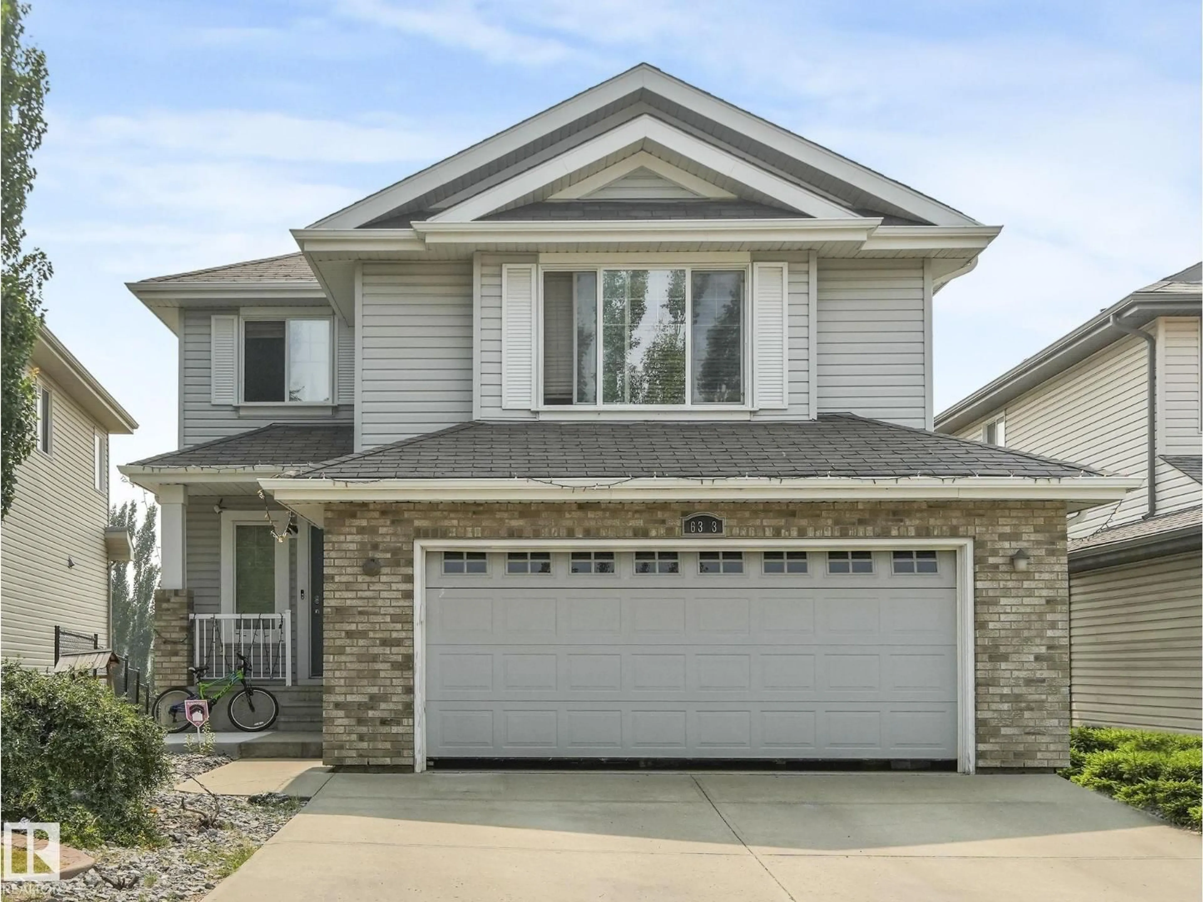 Home with vinyl exterior material, street for SW - 6303 4 AV, Edmonton Alberta T6X0C2