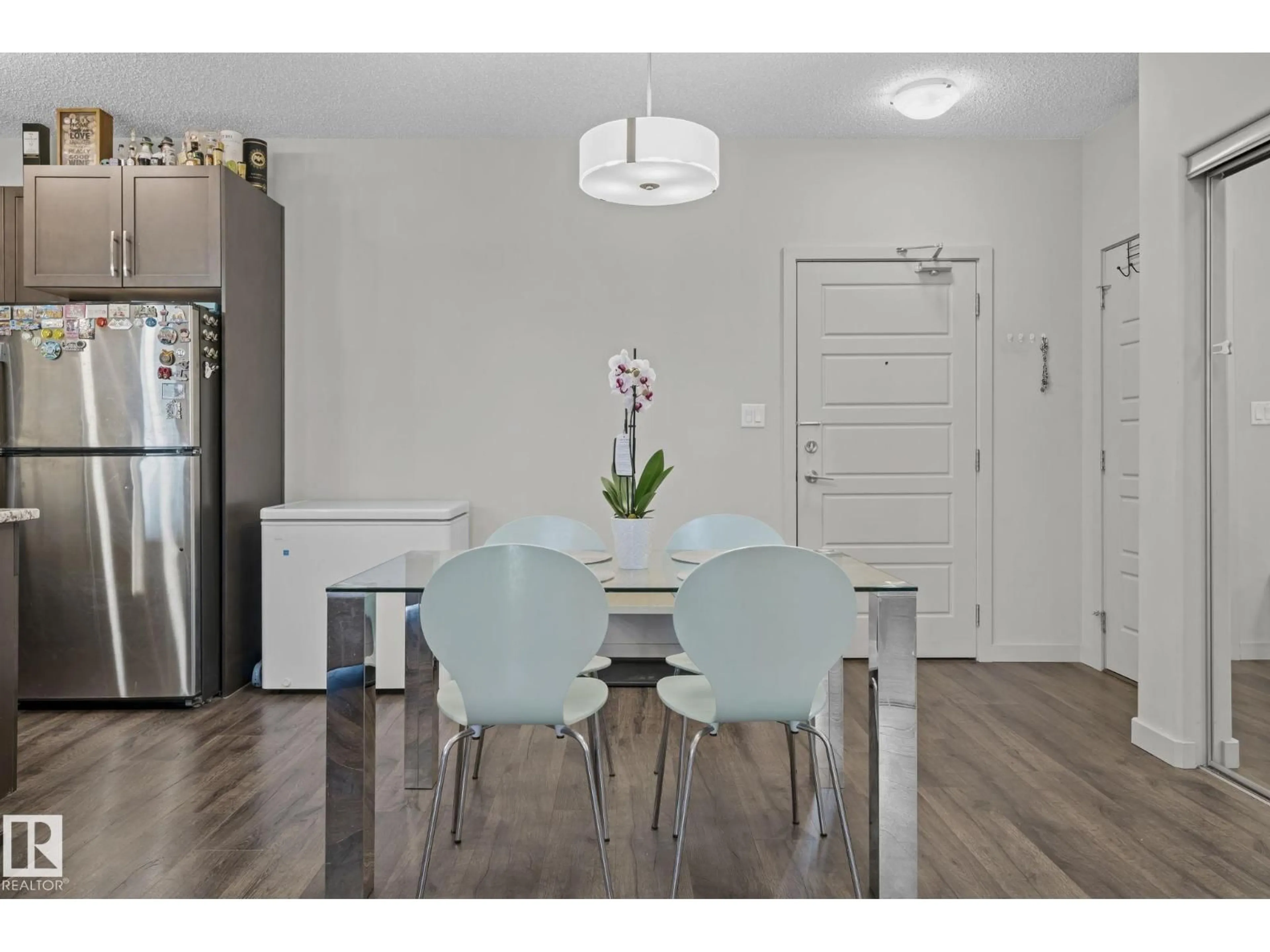 Dining room, wood/laminate floor for 207 - 320 AMBLESIDE LI, Edmonton Alberta T6W2Z9