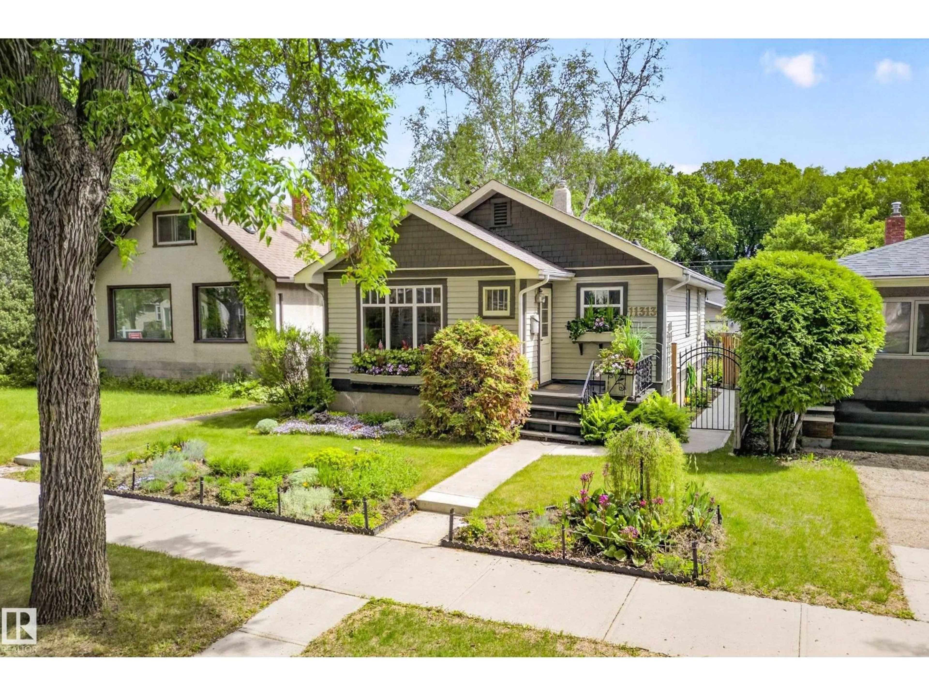 Home with vinyl exterior material, street for 11313 67 ST, Edmonton Alberta T5B1L2