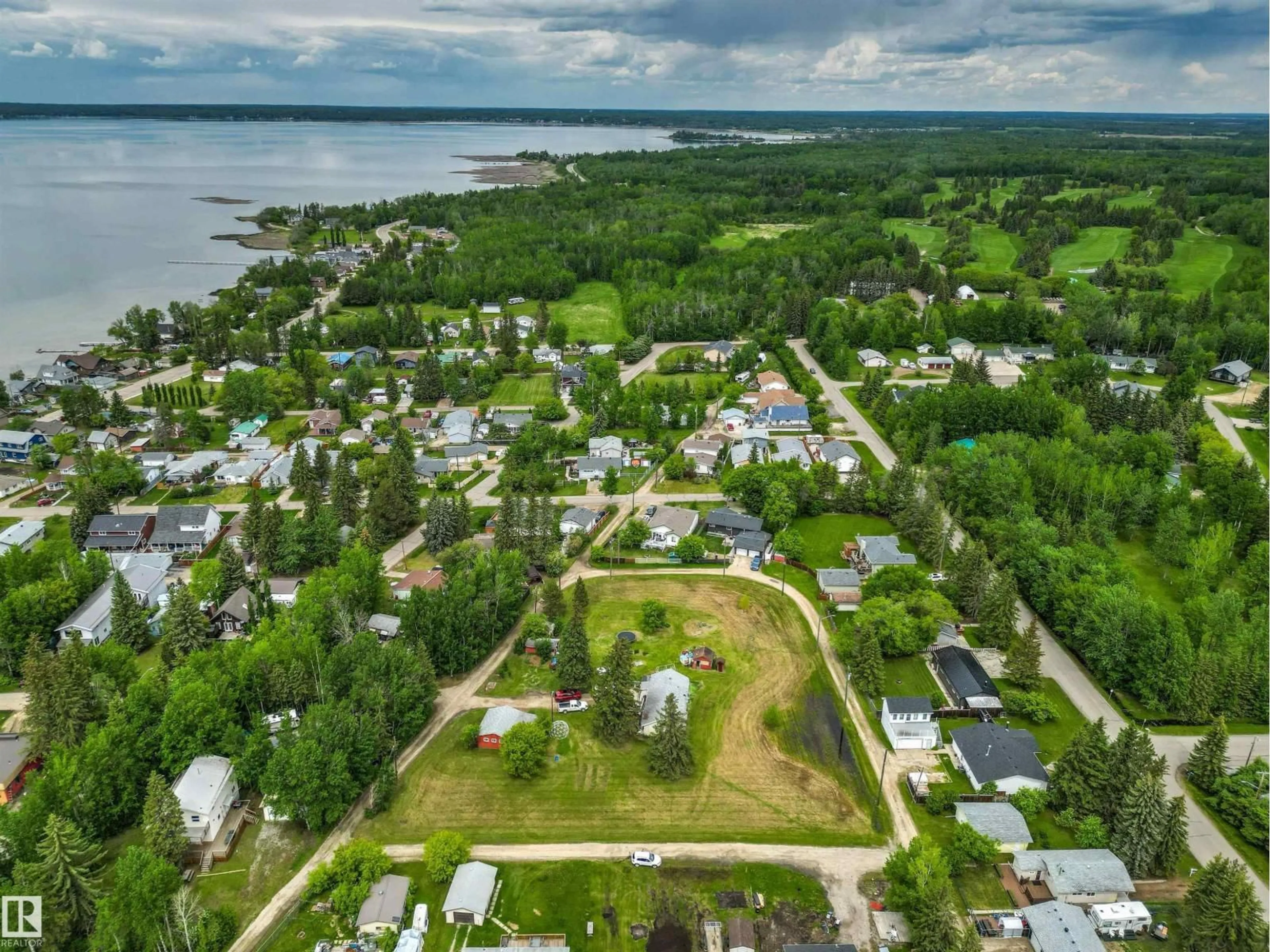 A pic from outside/outdoor area/front of a property/back of a property/a pic from drone, water/lake/river/ocean view for 4520 45 ST, Rural Lac Ste. Anne County Alberta T0E0E0