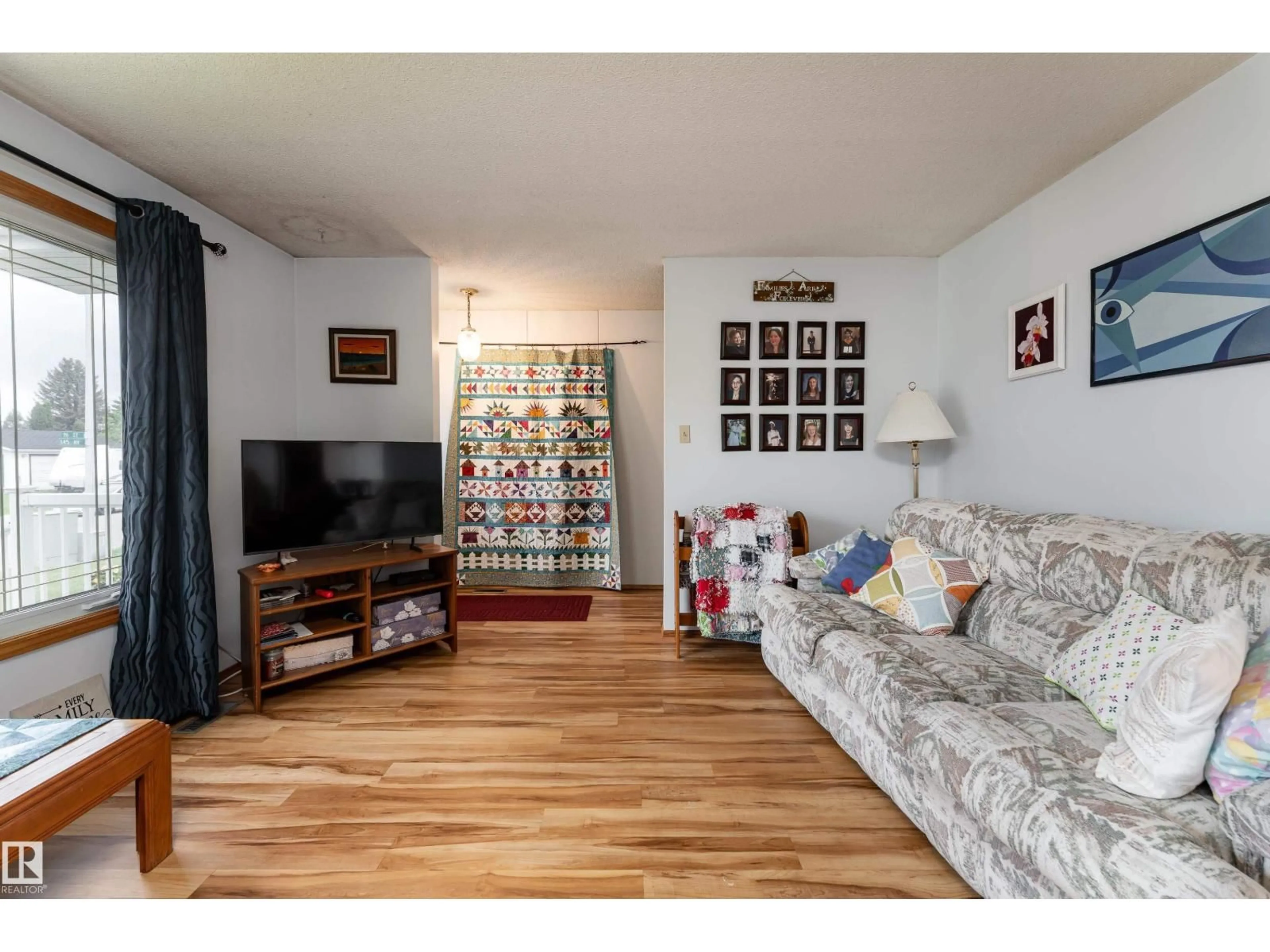 Living room with furniture, wood/laminate floor for 9559 145 AV, Edmonton Alberta T5E2J5