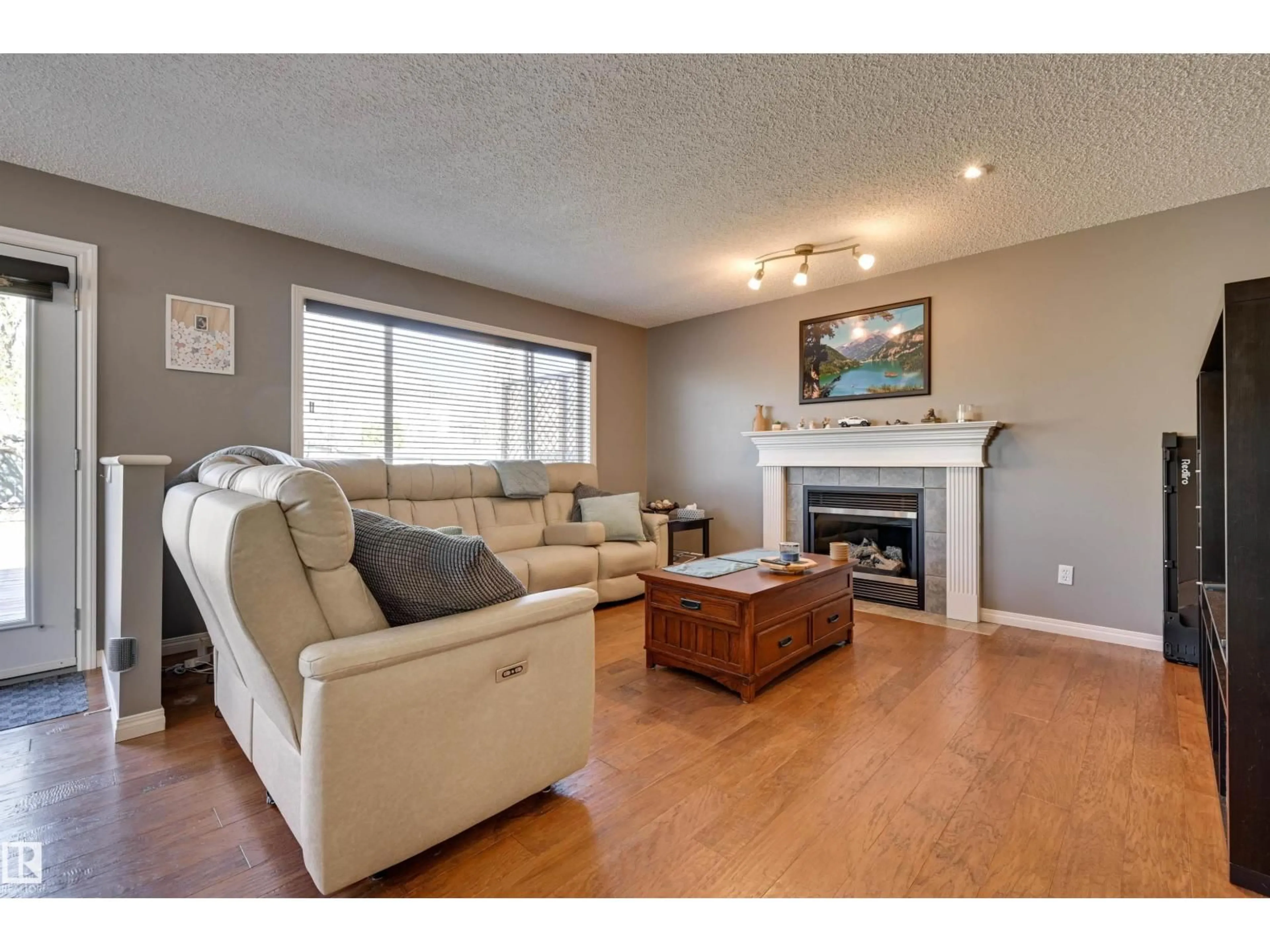 Living room with furniture, wood/laminate floor for 2208 BAKER CL, Edmonton Alberta T6W1G9