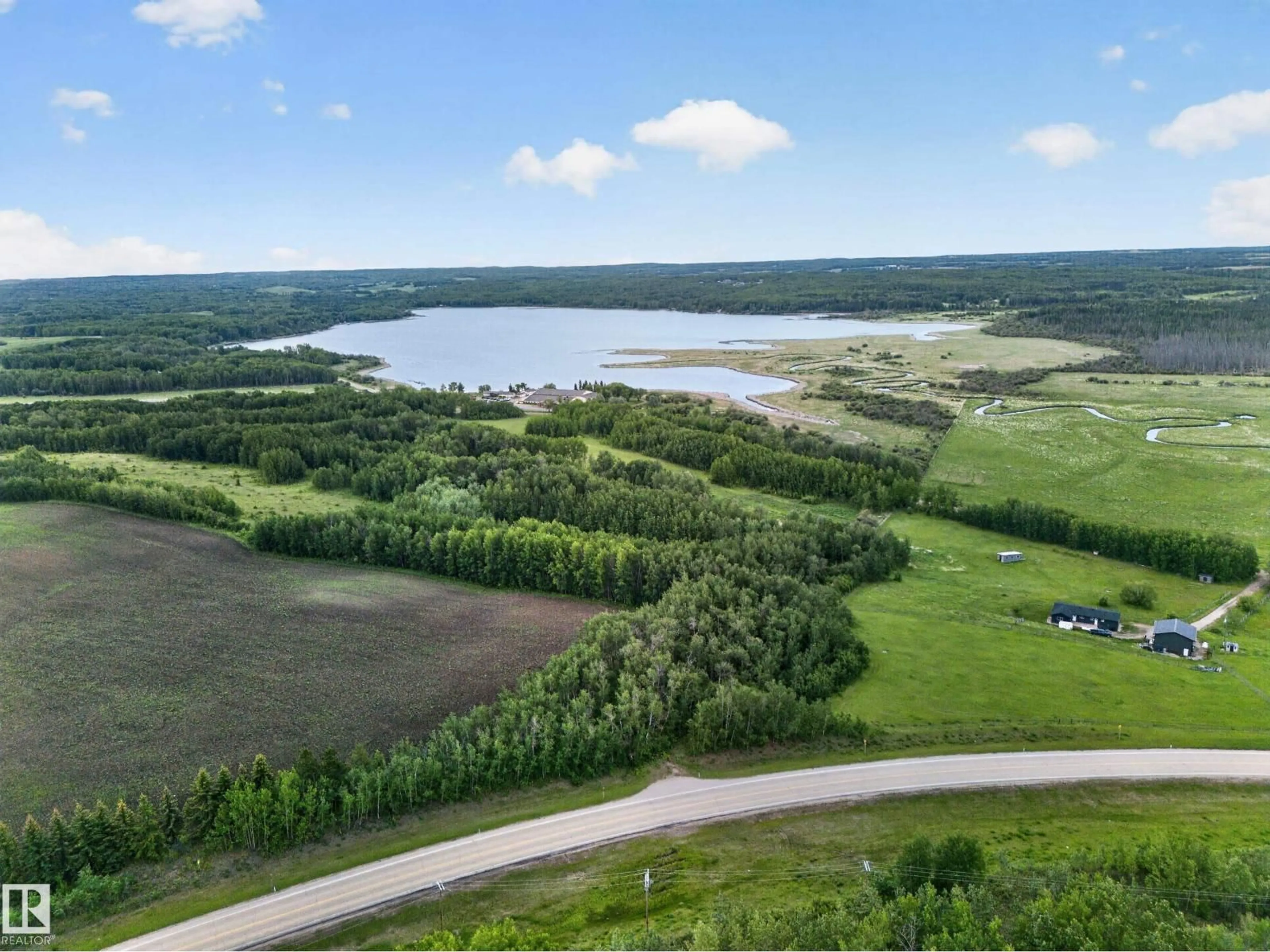 A pic from outside/outdoor area/front of a property/back of a property/a pic from drone, water/lake/river/ocean view for 1415 HWY 37, Rural Lac Ste. Anne County Alberta T0E1V0