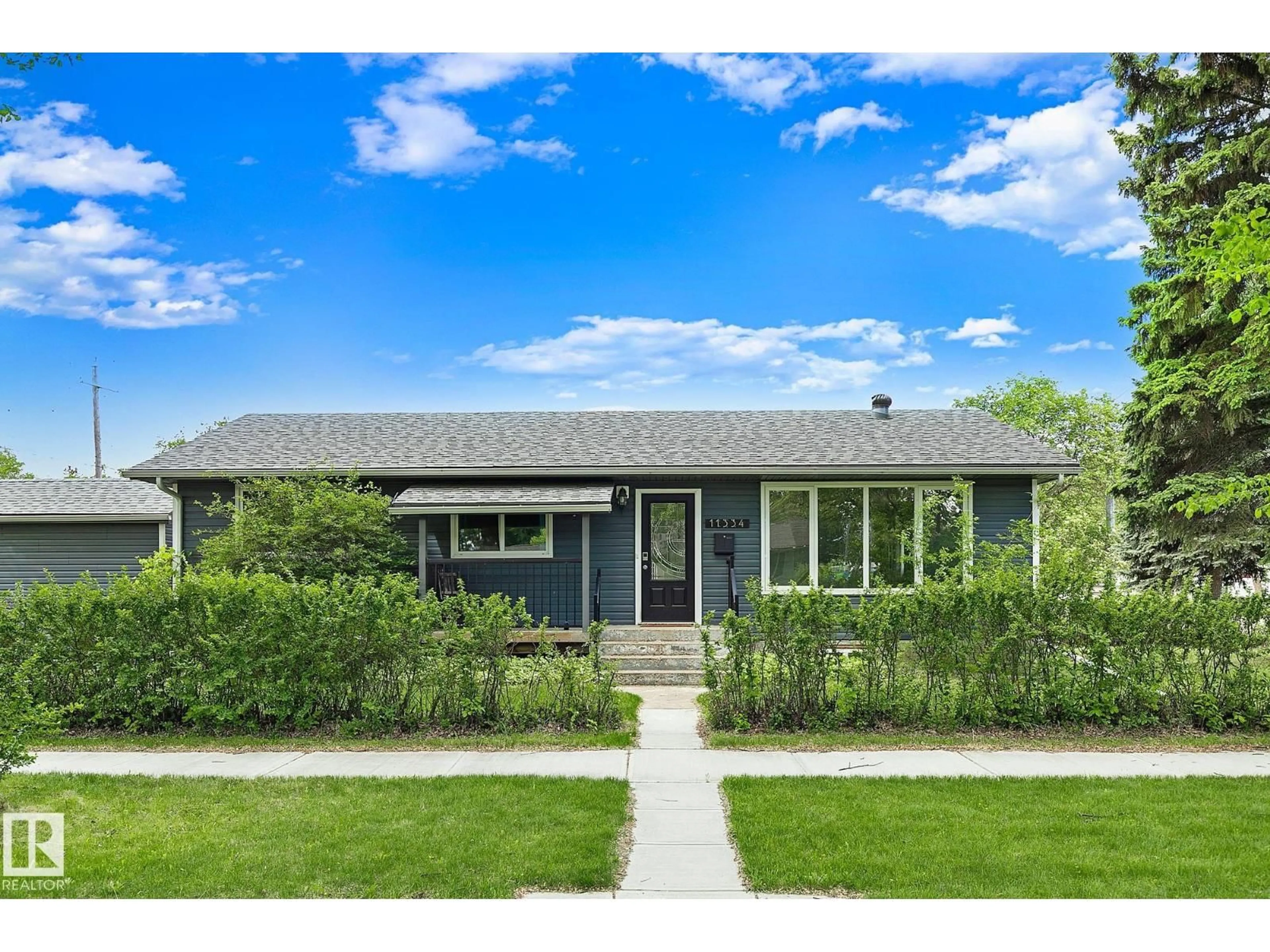 Home with vinyl exterior material, street for NW - 11334 52 ST, Edmonton Alberta T5W3J1