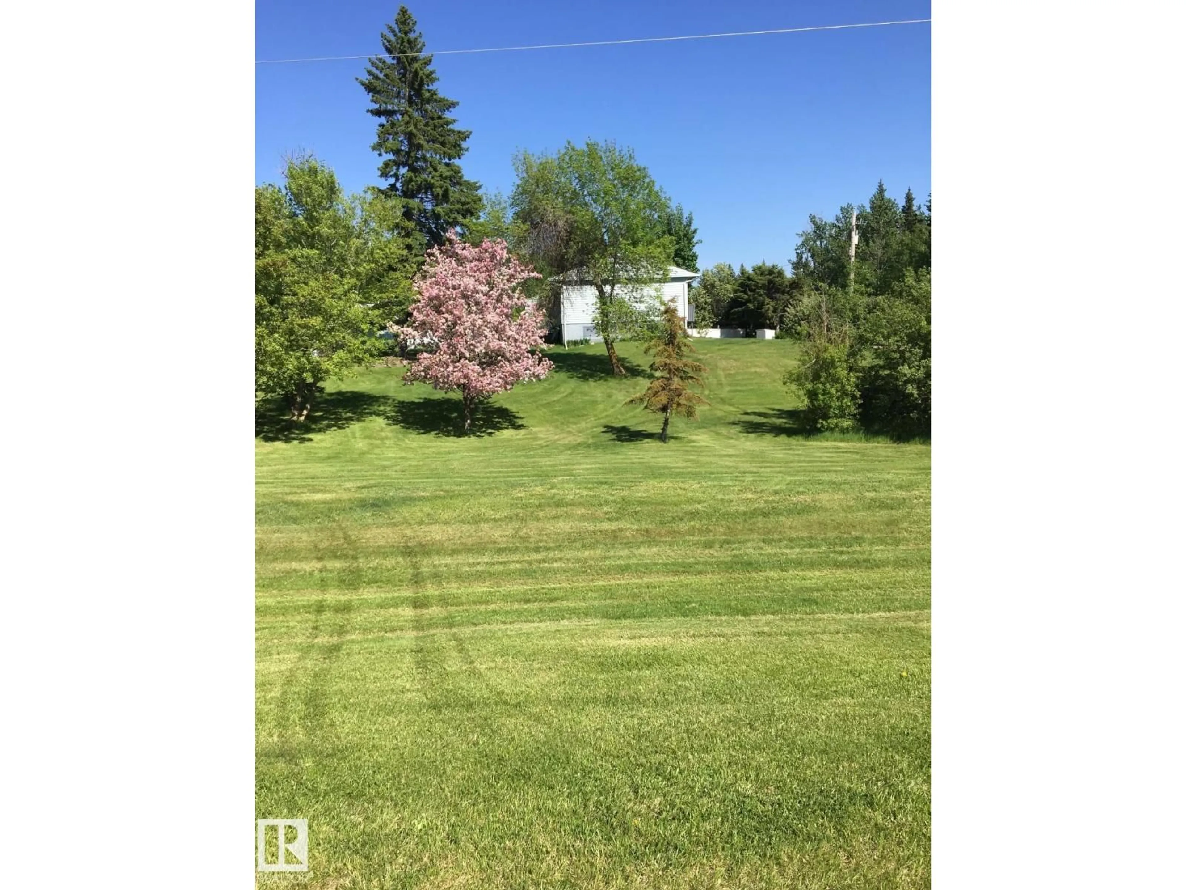 A pic from outside/outdoor area/front of a property/back of a property/a pic from drone, unknown for 22559 - 499 WYE RD, Rural Strathcona County Alberta T8B1J7