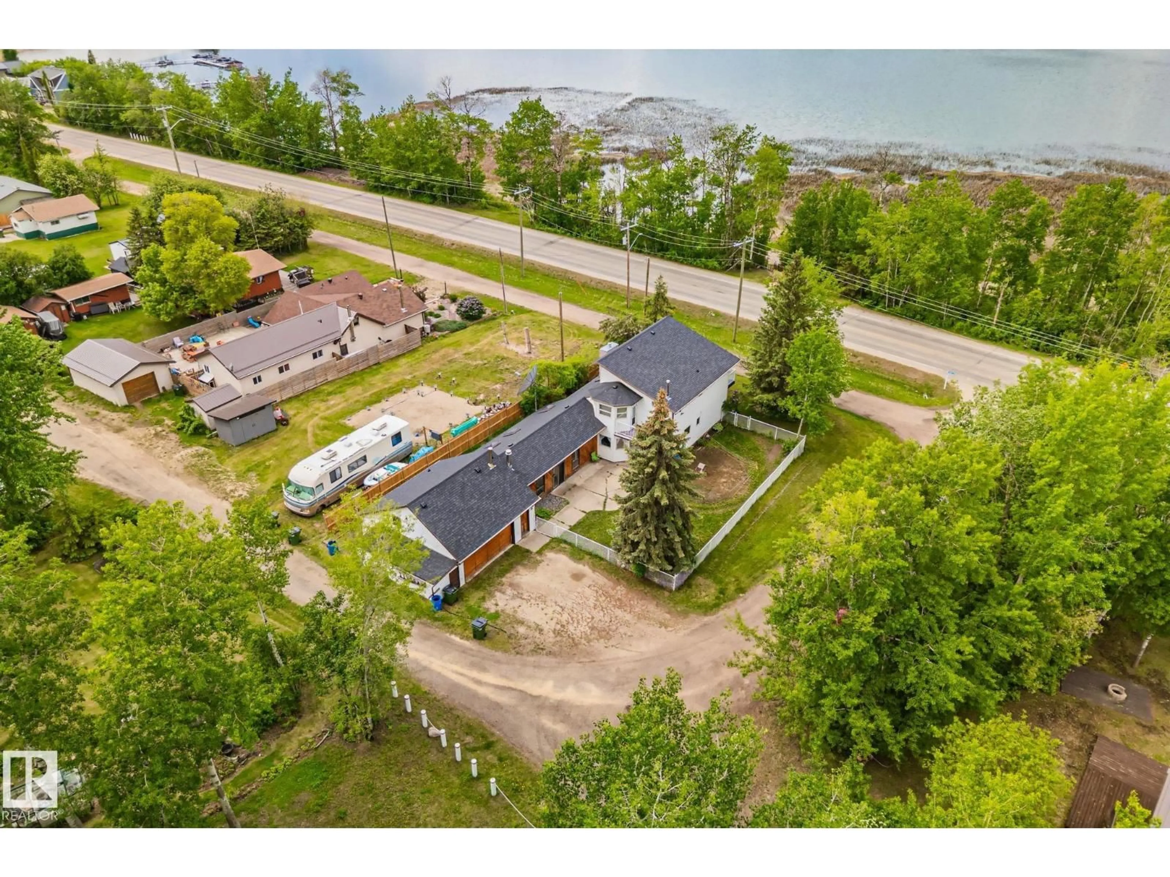 A pic from outside/outdoor area/front of a property/back of a property/a pic from drone, water/lake/river/ocean view for 5439 SUNSET DR, Rural Lac Ste. Anne County Alberta T0E0A0