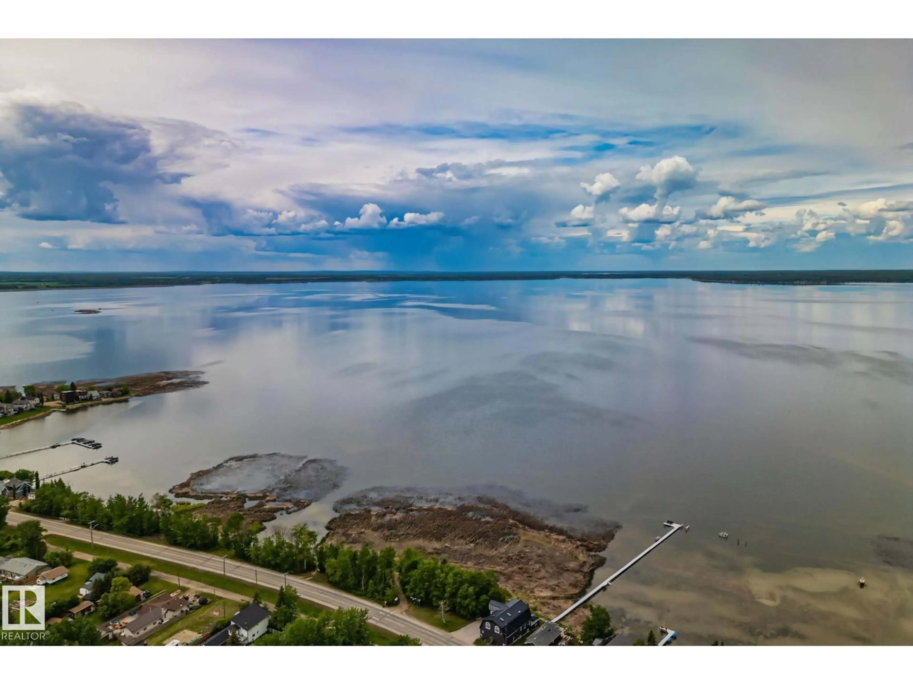 A pic from outside/outdoor area/front of a property/back of a property/a pic from drone, water/lake/river/ocean view for 5439 SUNSET DR, Rural Lac Ste. Anne County Alberta T0E0A0