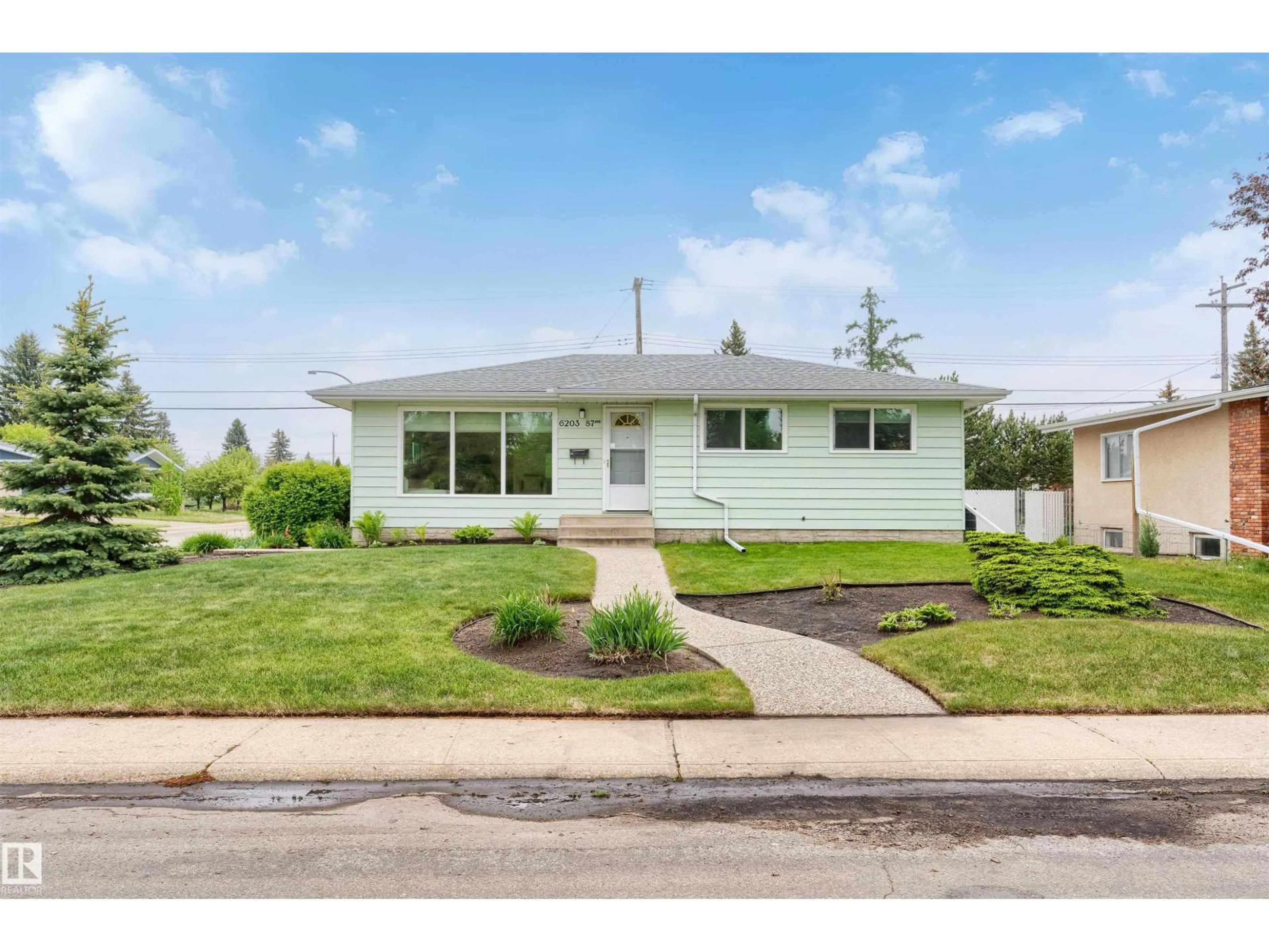 Home with vinyl exterior material, street for NW - 6203 87 AV, Edmonton Alberta T6B0L1