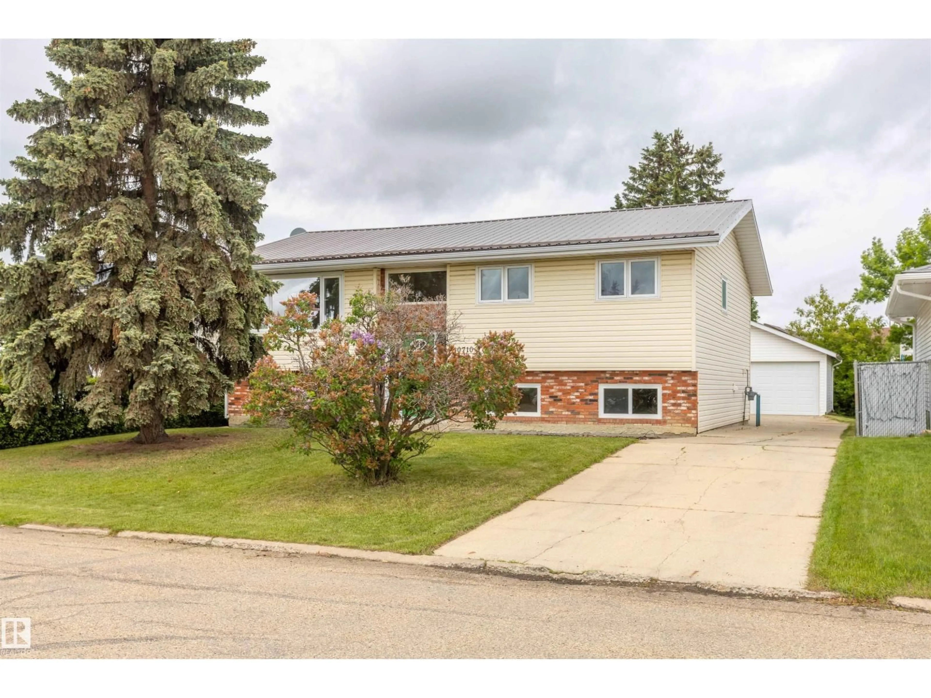 Home with vinyl exterior material, street for 10710 97 AV, Morinville Alberta T8R0E9