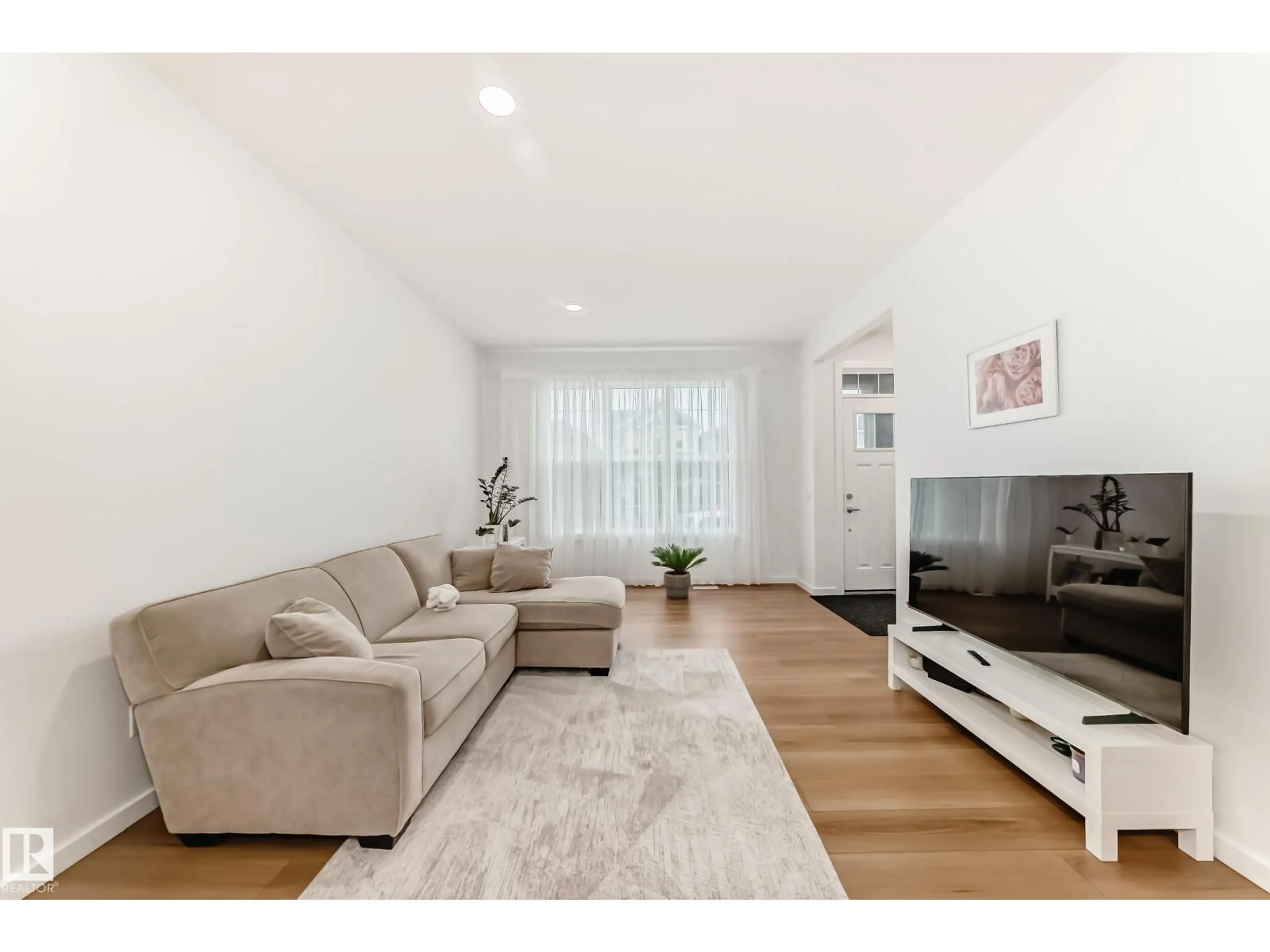 Living room with furniture, wood/laminate floor for 8129 226A STREET NW, Edmonton Alberta T5T7S8