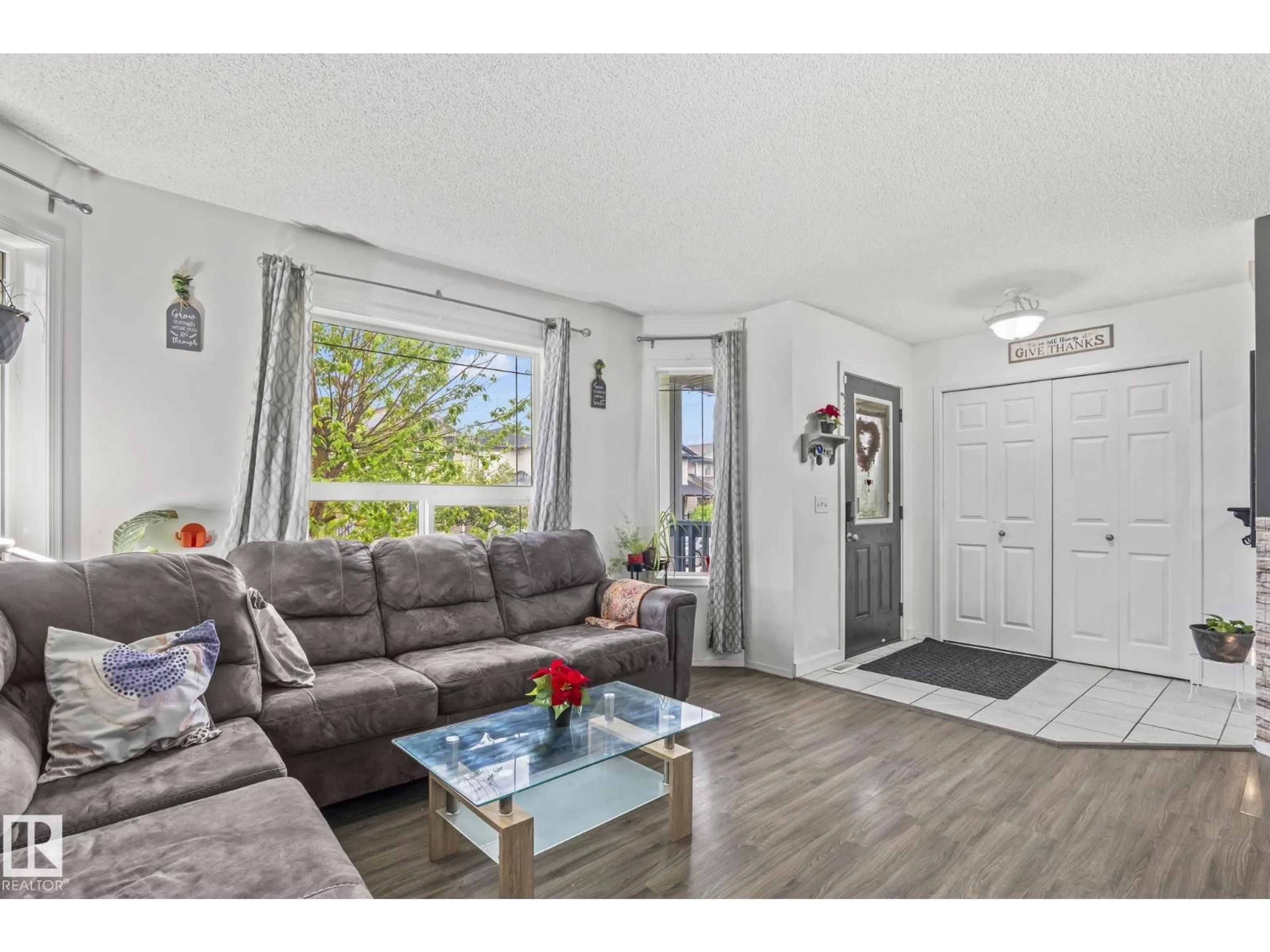 Living room with furniture, wood/laminate floor for 128 BROOKVIEW WY, Stony Plain Alberta T7Z2X6